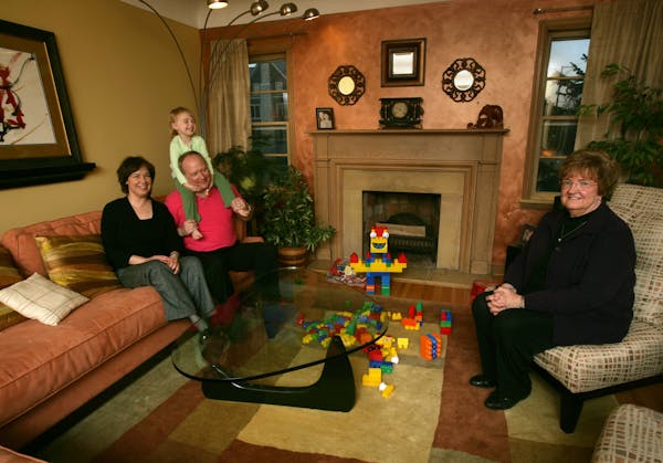 Julie Hovland, her husband Ron Scroggins, daughter Ava Scroggins and Julie's mother Kathy Hovland in their living room.