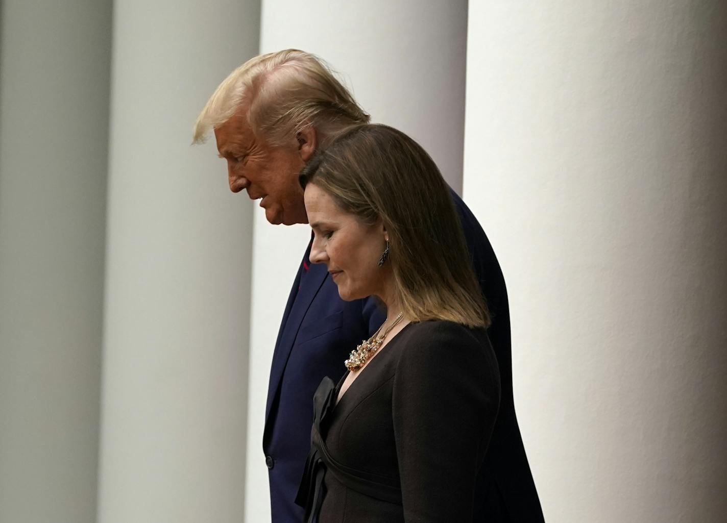 President Donald Trump walks with Judge Amy Coney Barrett to a news conference to announce Barrett as his nominee to the Supreme Court, in the Rose Garden at the White House, Saturday, Sept. 26, 2020, in Washington. (AP Photo/Alex Brandon)