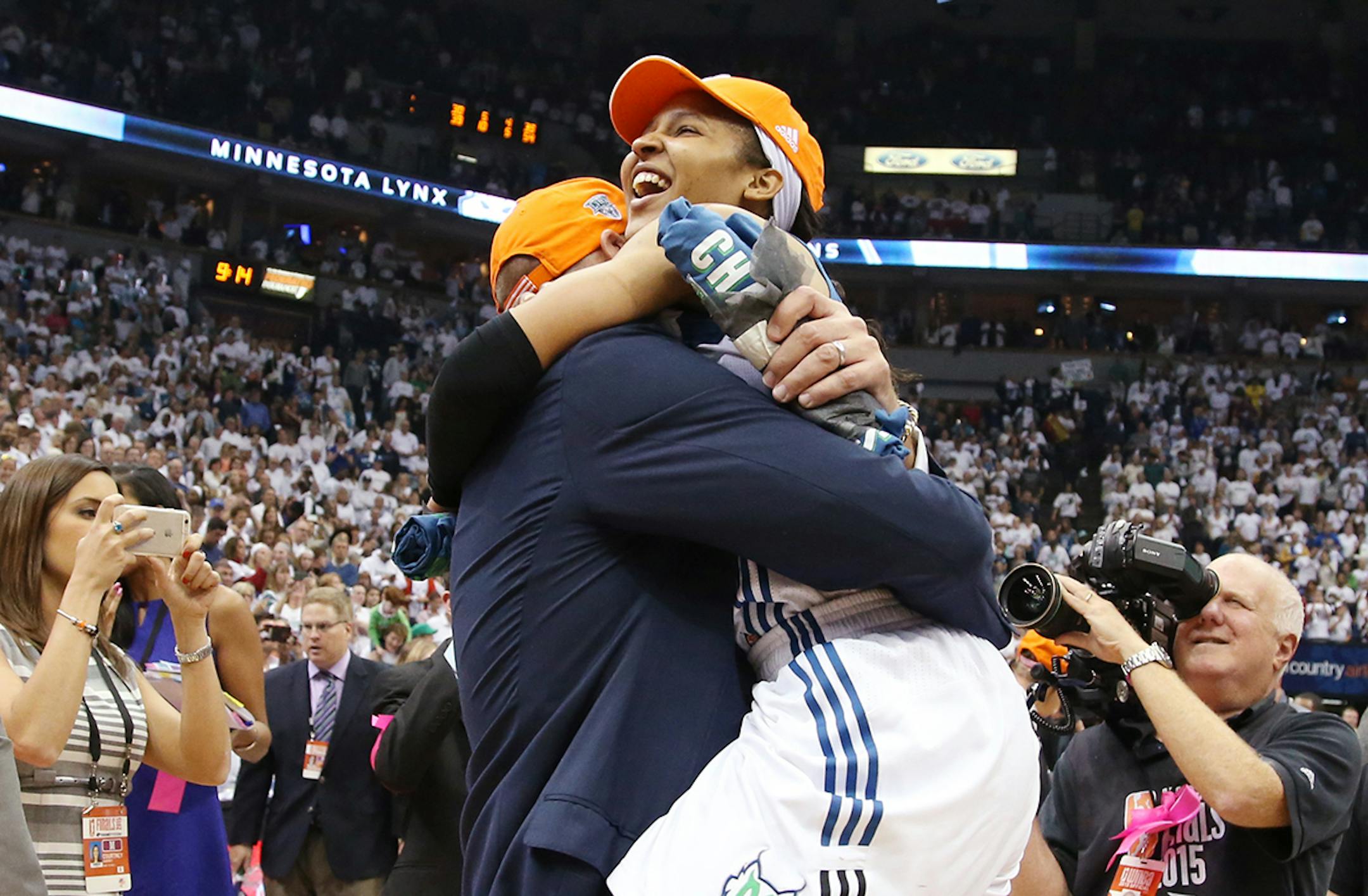 Minnesota Lynx forward Maya Moore (23) celebrates with assistant coach Jim Petersen.