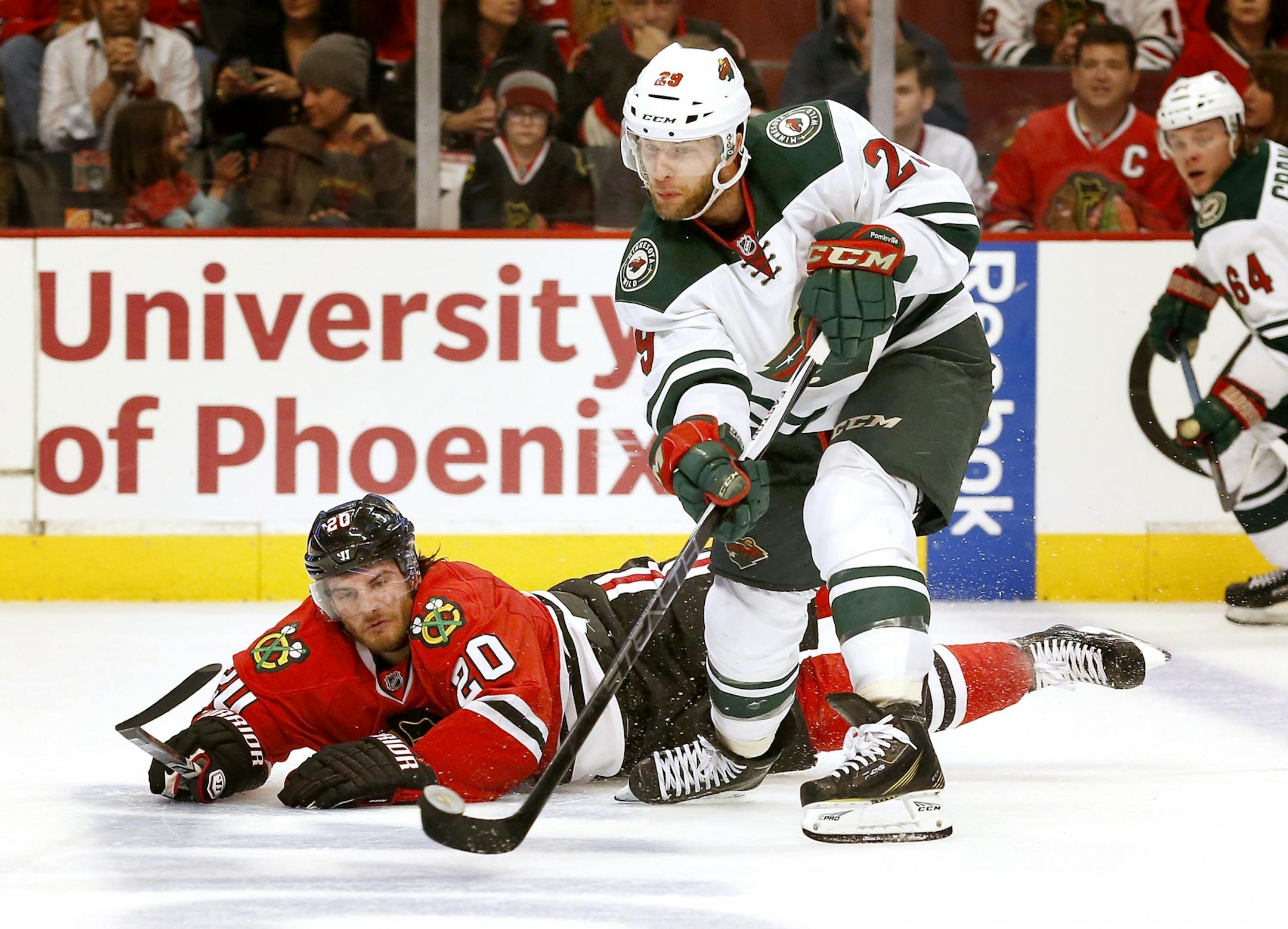 Jason Pominville (29) passed the puck to a teammate while being defended by Brandon Saad (20) in the third period.