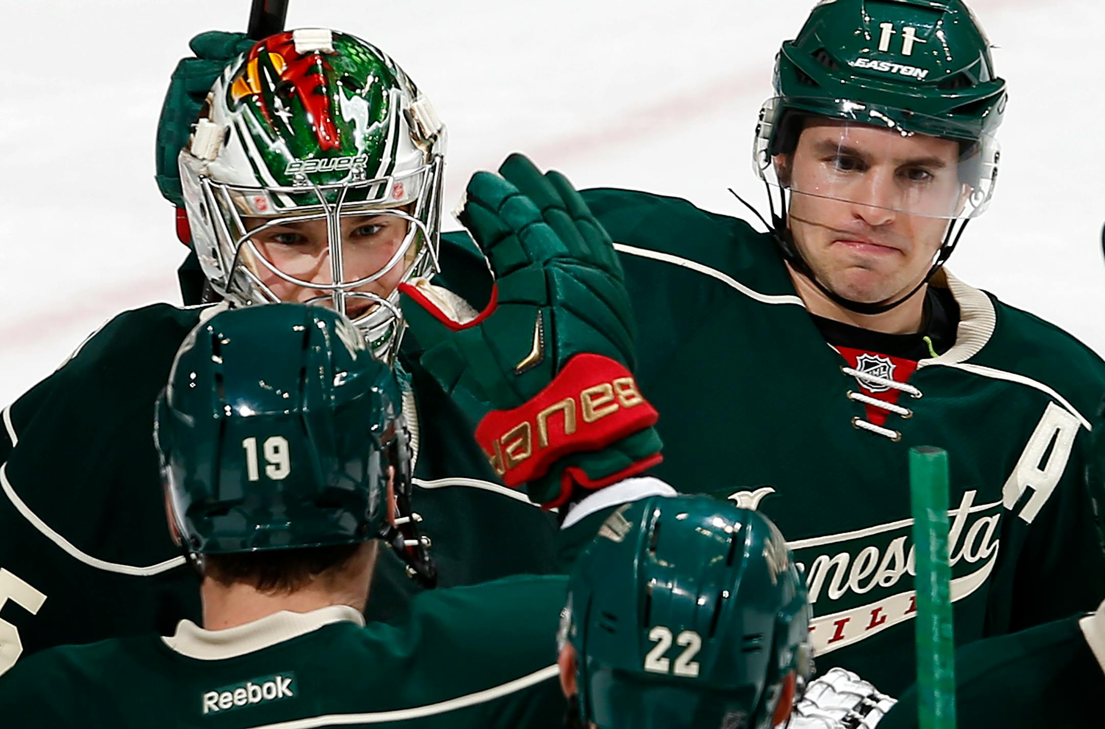 Wild goalie Darcy Kuemper, left, received congratulations from Zach Parise, right, Jarret Stoll (19) and Nino Niederreiter (22) after stopping 24 of 25 shots in a 2-1 victory over Montreal on Tuesday night at Xcel Energy Center.