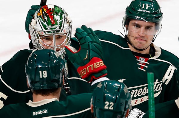 Wild goalie Darcy Kuemper, left, received congratulations from Zach Parise, right, Jarret Stoll (19) and Nino Niederreiter (22) after stopping 24 of 2