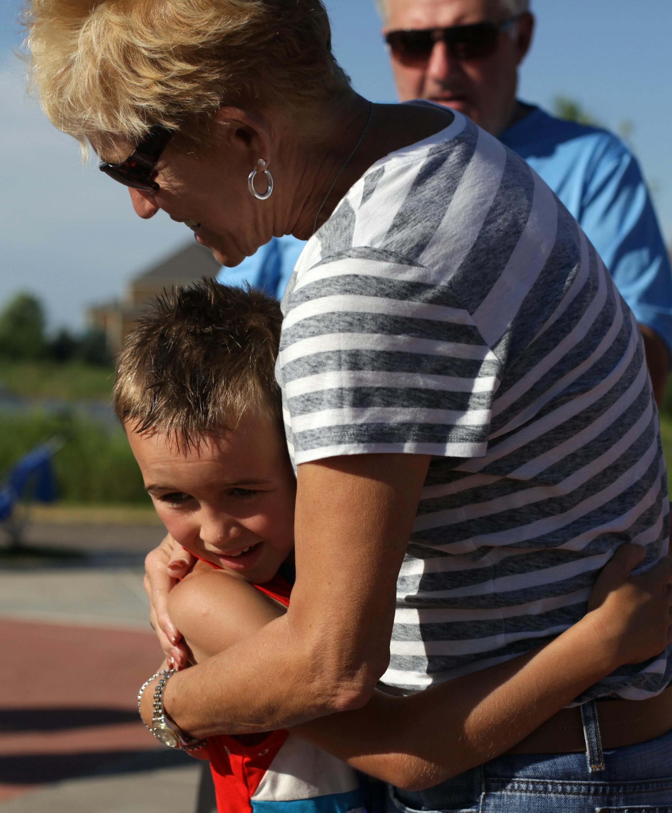 Hale Gulan,7, hugs his grandma, Millie Halden, after completing the Kid's Triathlon on Saturday morning at Lakeside Commons Park. ] Blaine hosted their first Kid's Triathlon on Saturday morning at Lakeside Commons Park. The competitors completed a 165 yard swim, 2.3 mile bike ride, and 1 mile run. MONICA HERNDON monica.herndon@startribune.com Blaine MN 07/26/14
