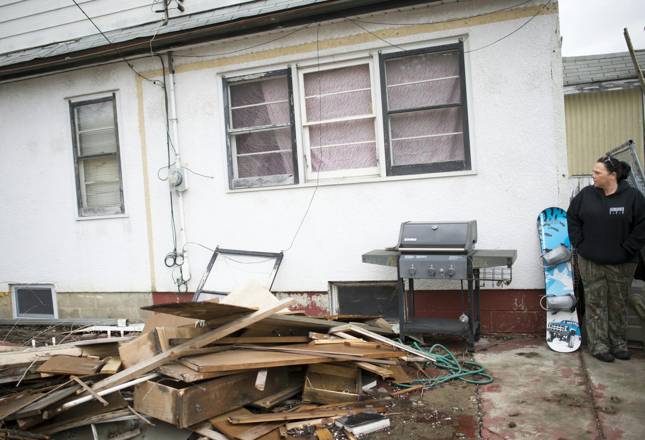 Lisa Snidarich, a tenant of a South St. Paul home owned by William Bernier, stands next to a pile of rubbish that she said was left behind by previous tenants in her backyard. The backyard is littered with Styrofoam, abandoned grills, sharp metal objects and previous tenants' dogs' feces. ] (Aaron Lavinsky | StarTribune) Lisa Snidarich needed a place to live, fast. She was getting divorced and has four kids. So when William Bernier said he would clean up a South St. Paul home, she believed him.