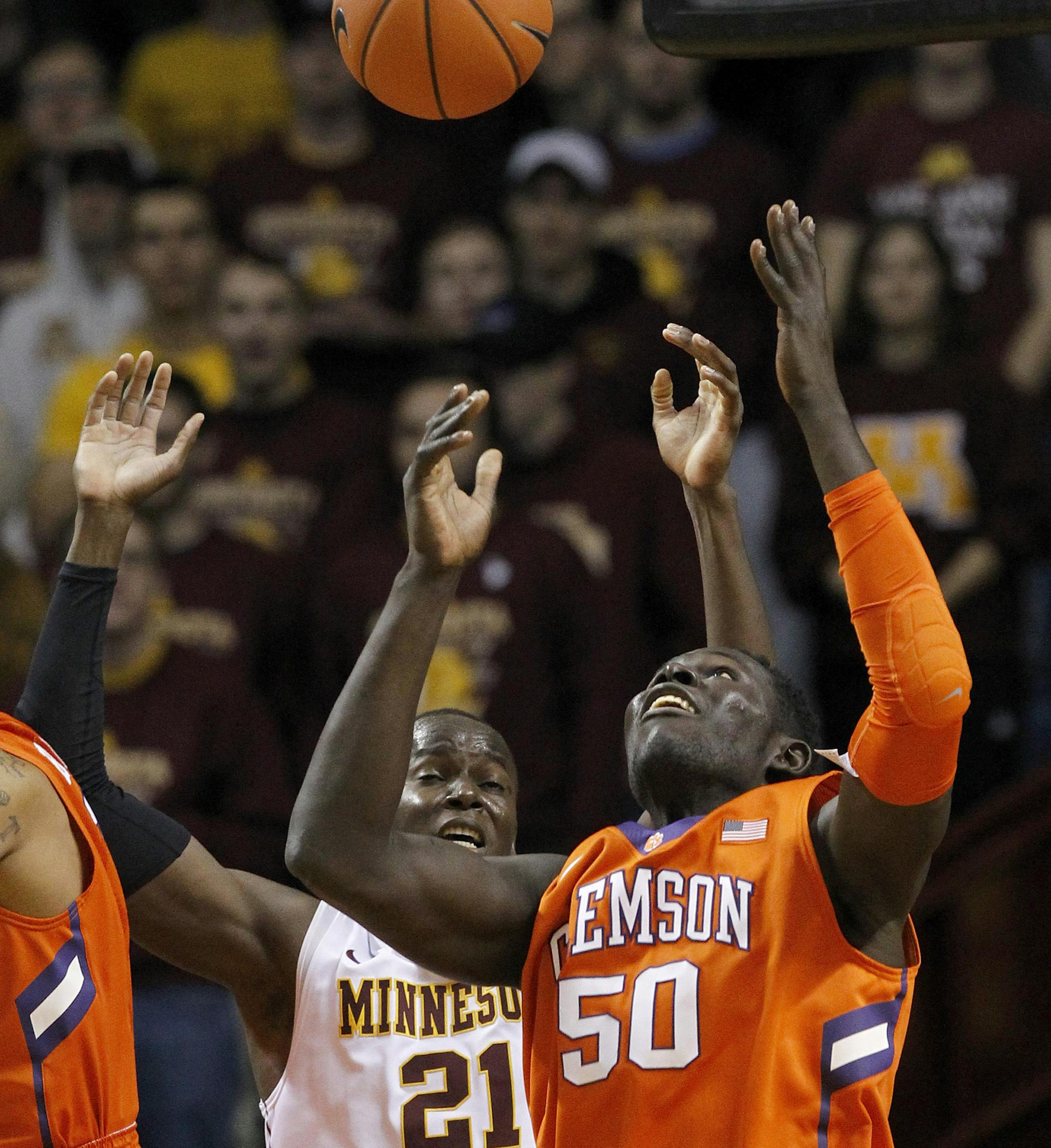 Clemson center Sidy Djitte (50) and Minnesota center Bakary Konate (21) vie for a rebound during the first half of an NCAA college basketball game in Minneapolis, Monday, Nov. 30, 2015. (AP Photo/Ann Heisenfelt)