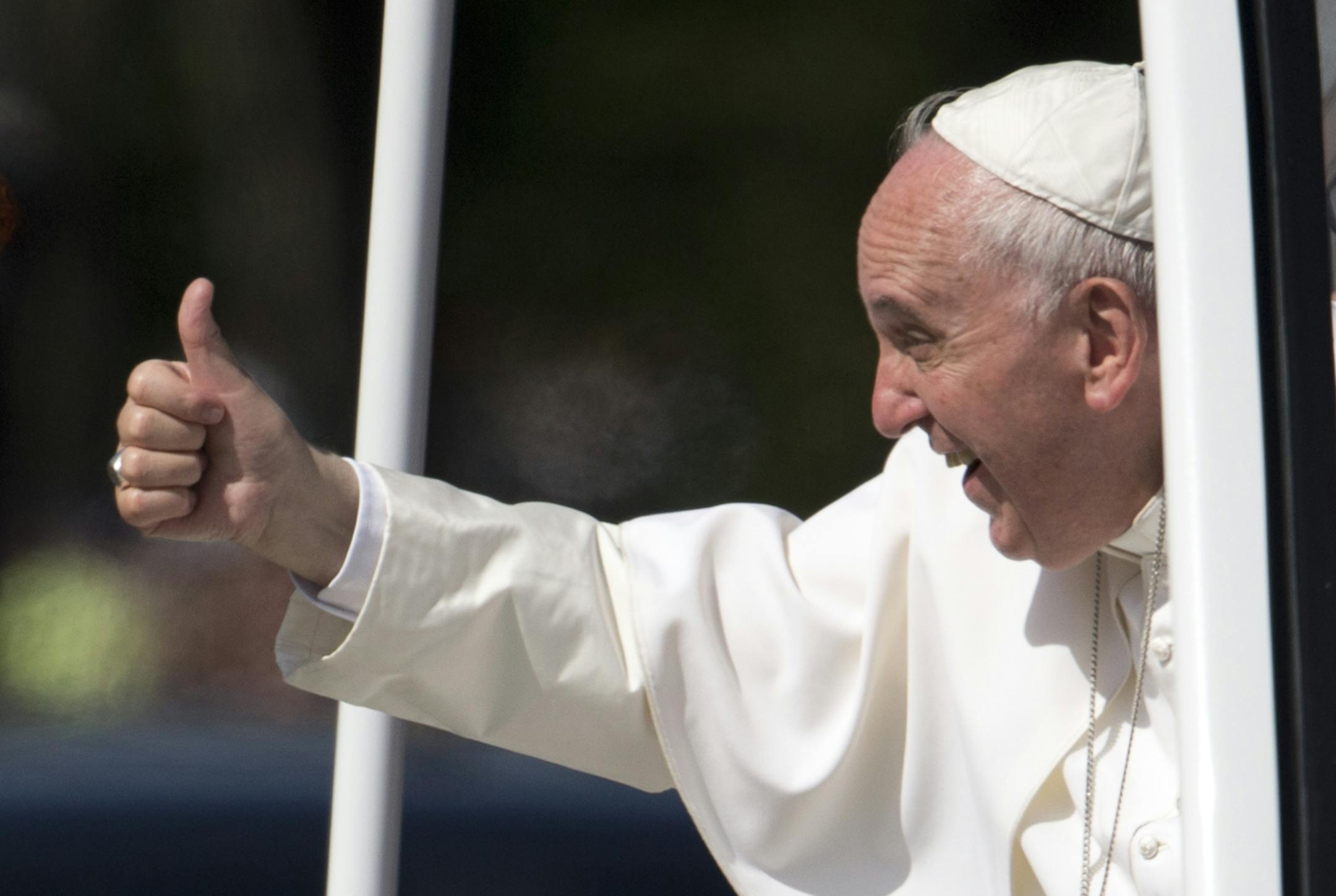 Pope Francis give the thumbs-up from the popemobile during a parade around the Ellipse near the White House in Washington, Wednesday, Sept. 23, 2015. (AP Photo/Carolyn Kaster)
