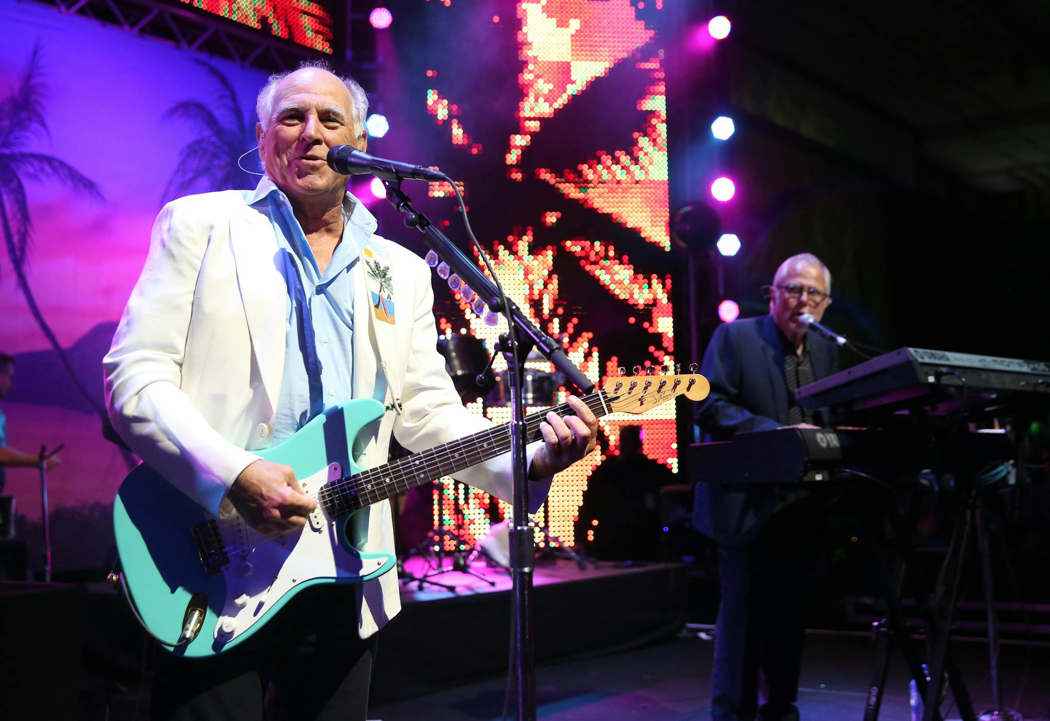 FILE - In this June 9, 2015 file photo, Jimmy Buffett performs at the after party for the premiere of "Jurassic World" in Los Angeles. Producers said Wednesday, Feb. 3, 2016, that a Jimmy Buffett musical, combining Buffett's blend of rock and country tunes with an original story by writers Greg Garcia and Mike O'Malley will open at the La Jolla Playhouse in California on May 16, 2017. (Photo by Matt Sayles/Invision/AP, File)