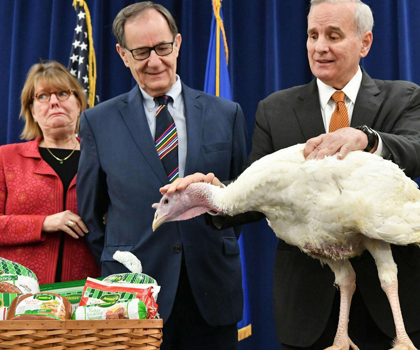 Colleen Moriarty of Hunger Solutions looked nervous as the Governor's turkey eyeballed a tray of Jenni-O turkey products next to him. Governor Mark Dayton stroked his head, keeping him calm. Between them, Ag Commissioner Dave Frederickson. Between them, Ag Commissioner Dave Frederickson. This Minnesota Turkey will not be named or pardoned but like 46 million Minnesota turkeys is headed to the food stream. ] GLEN STUBBE * gstubbe@startribune.com Monday, November 21, 2016 Gov. Mark Dayton holds hi