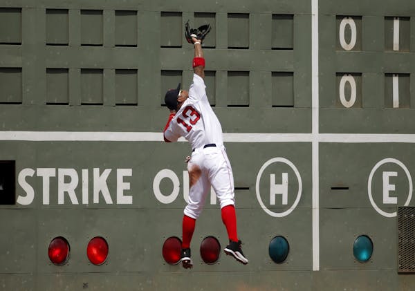 The Red Sox's Carl Crawford made a catch on a ball hit by the Twins' Ryan Doumit near the Green Monster in Boston's Fenway Park last August.