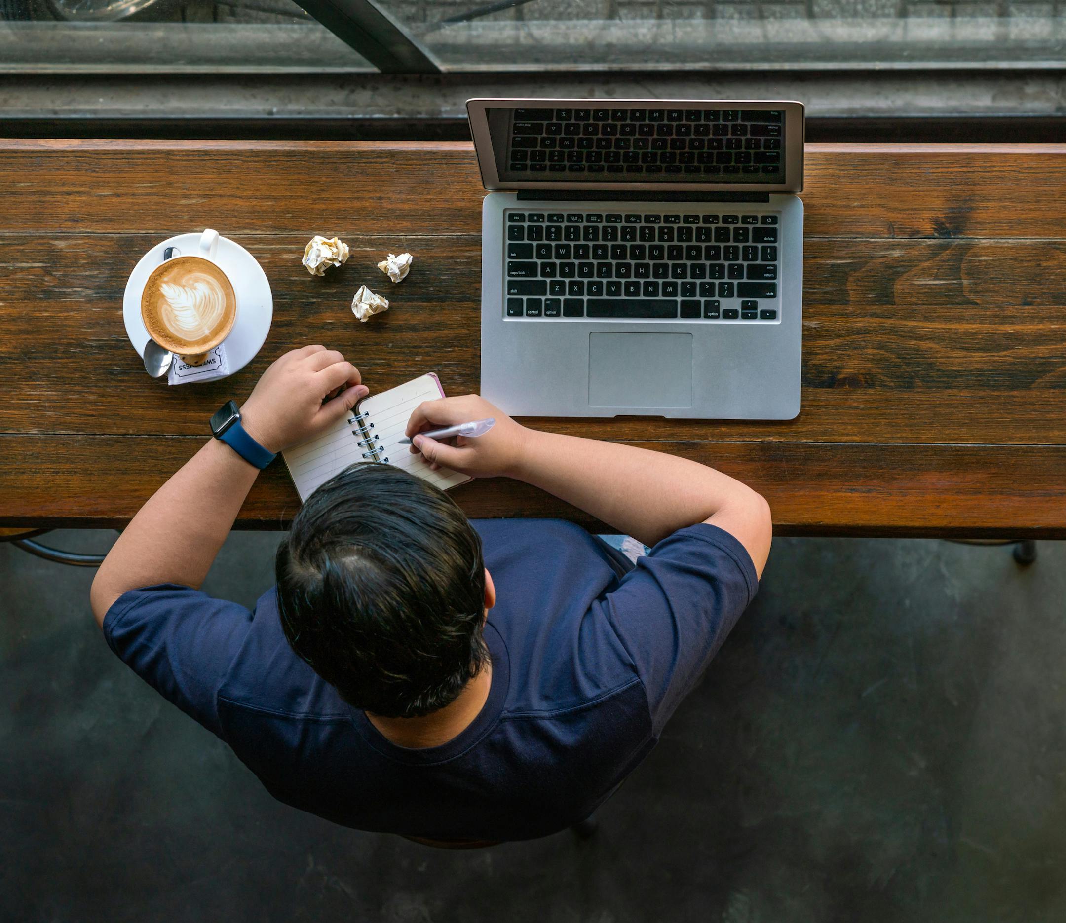 Asian woman writing notes about marketing content