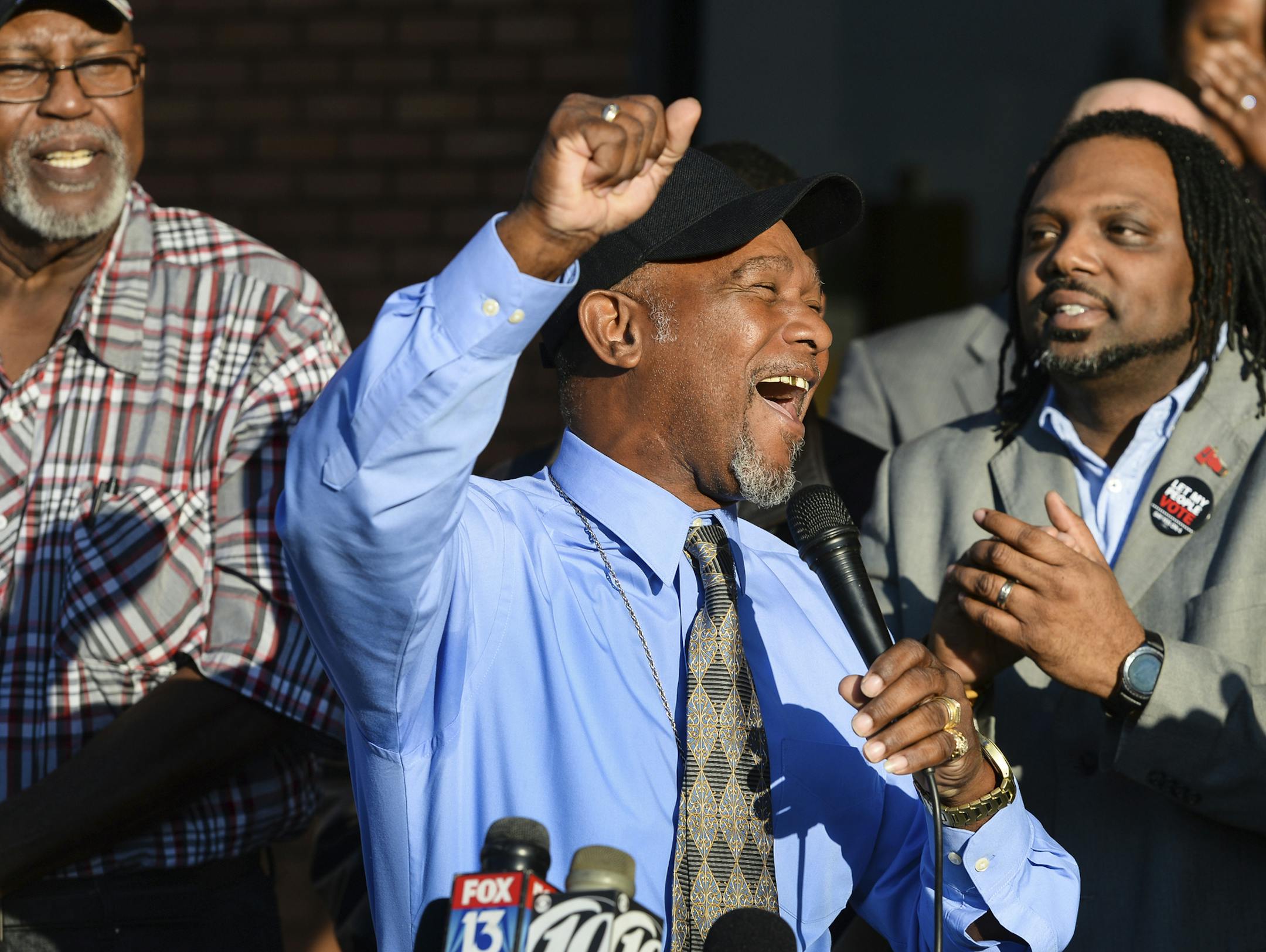 Pastor Wesley Tunstall praises God while addressing media at the Sarasota County Supervisor of Elections Office on Tuesday, Jan. 8, 2019, in Sarasota, Fla. Tunstall, a convicted felon, registered to vote on Tuesday, the first day that Amendment 4, which restores the right to vote for most felons, went into effect. (Dan Wagner/Sarasota Herald-Tribune via AP)
