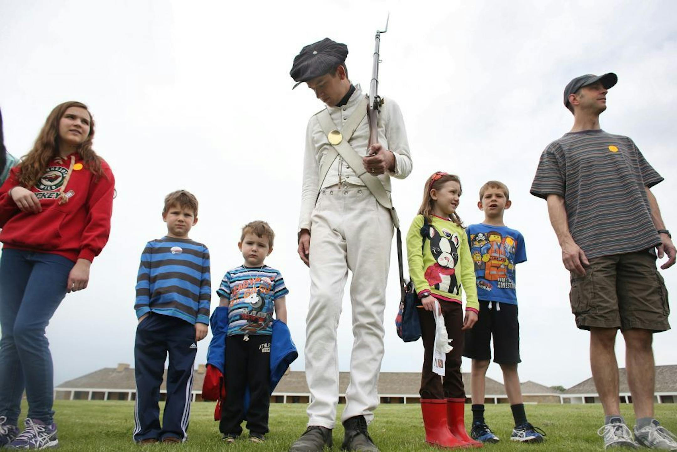 Eric Olson helped with some civilians as they practiced marching after the infantry performed their drills on the lawn.