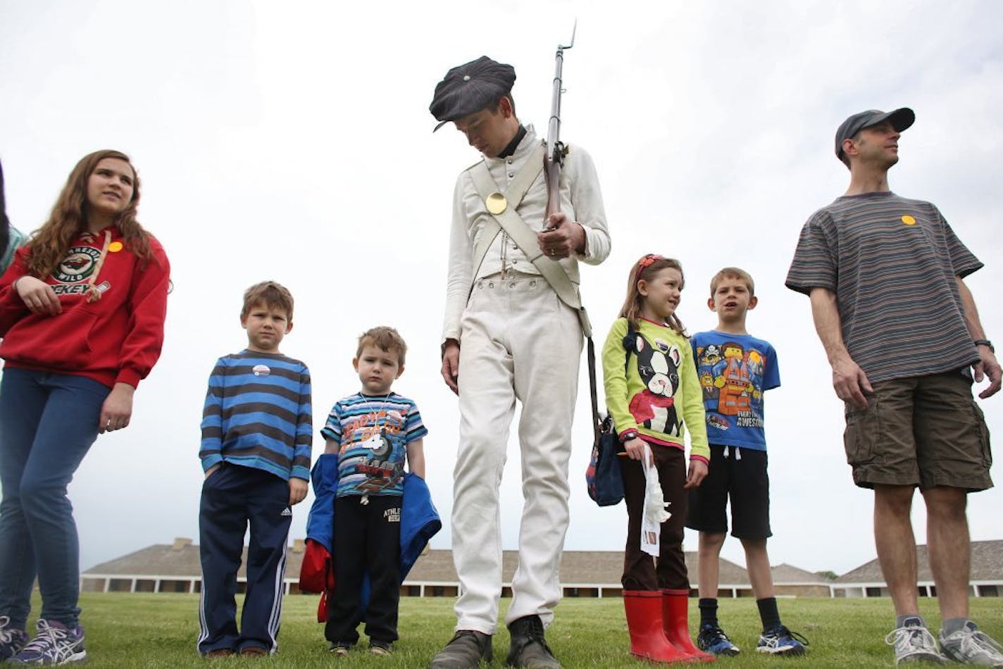 Eric Olson helped with some civilians as they practiced marching after the infantry performed their drills on the lawn.