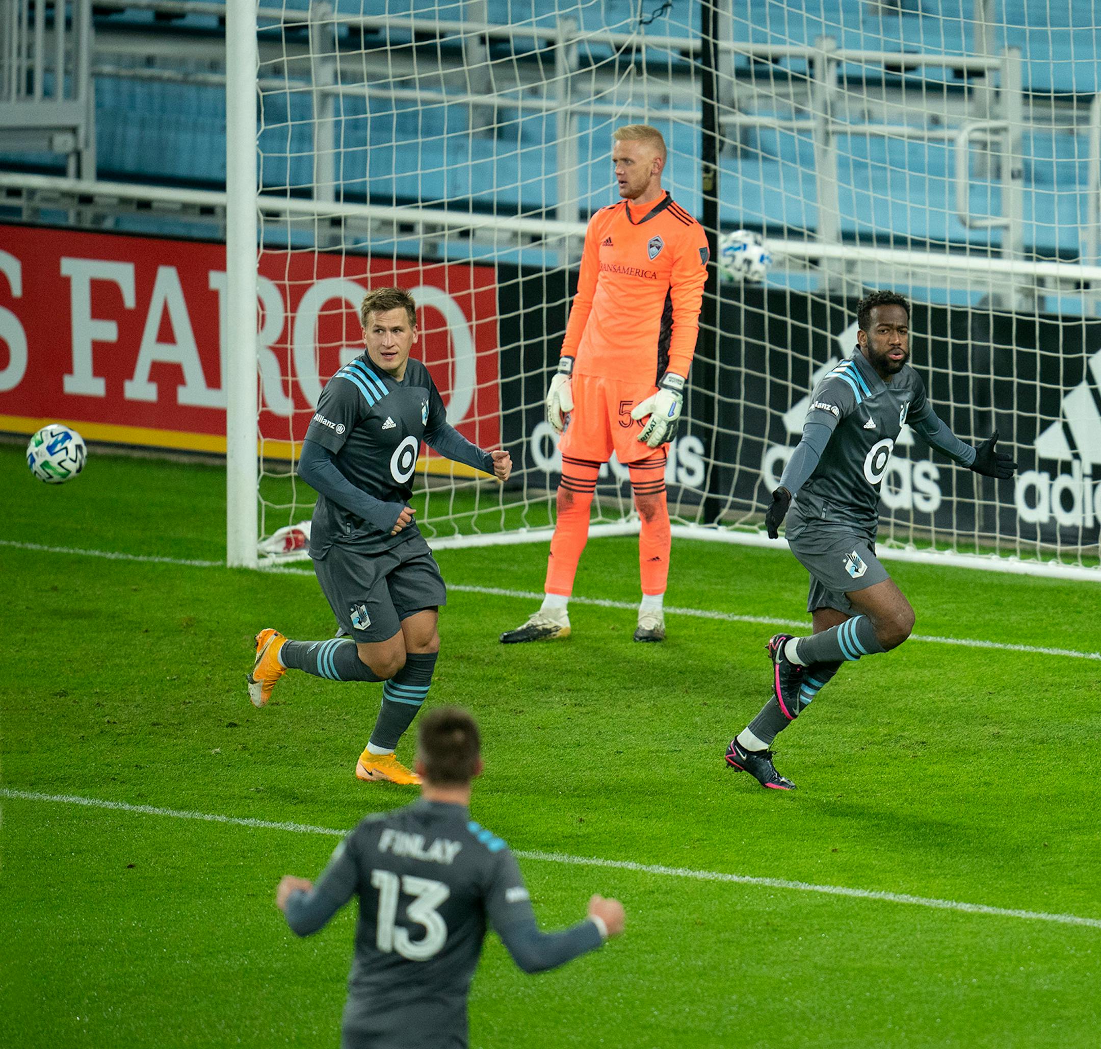 Minnesota United midfielder Kevin Molino (7) celebrated his first half goal with teammates midfielder Robin Lod (17) and midfielder Ethan Finlay (13) in front of Colorado Rapids goalkeeper William Yarbrough (50).