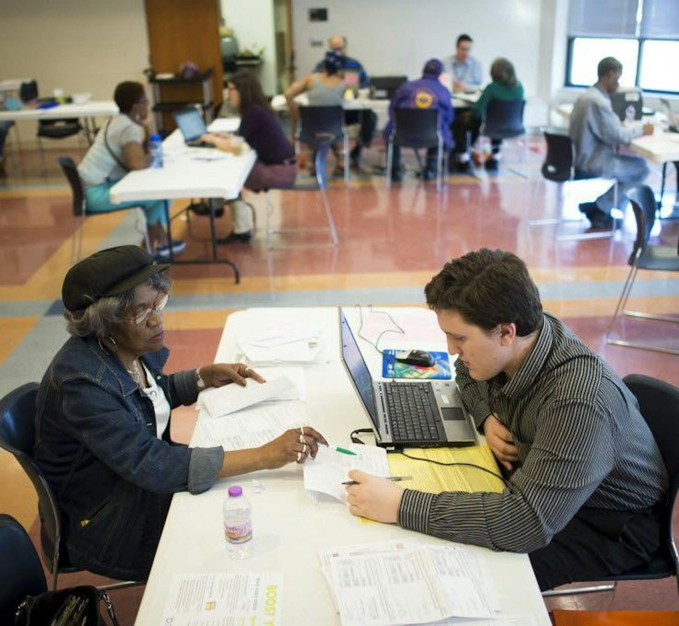 Michael Miller, a volunteer tax preparer with the nonprofit Prepare + Prosper, worked with a client to file her taxes.