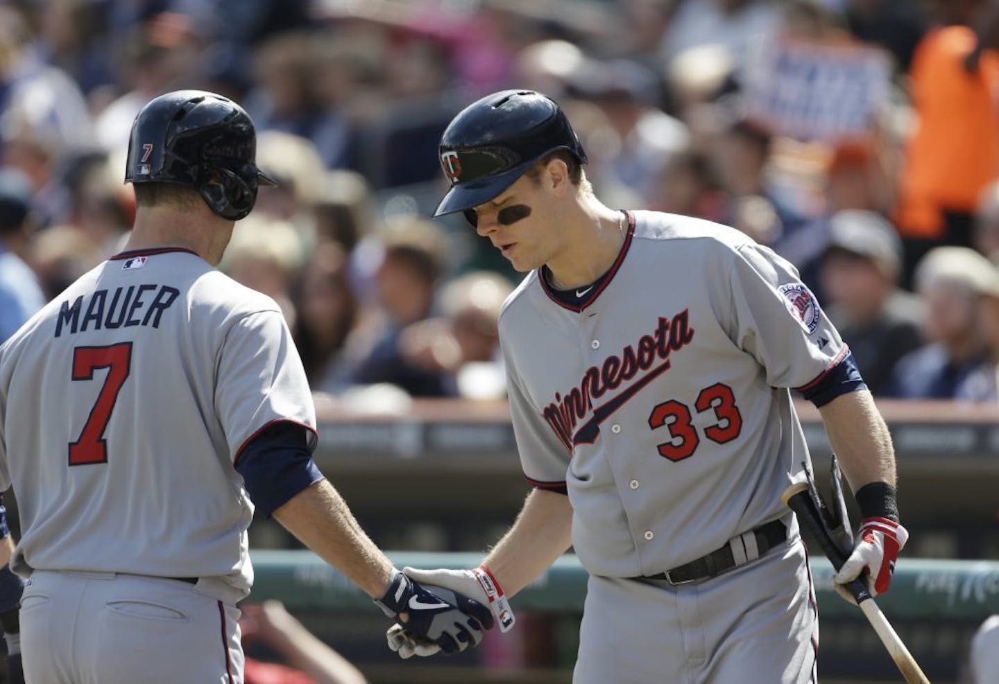 Justin Morneau, right, congratulates teammate Joe Mauer after Mauer's solo home run during the first inning off Detroit Tigers starting pitcher Doug Fister