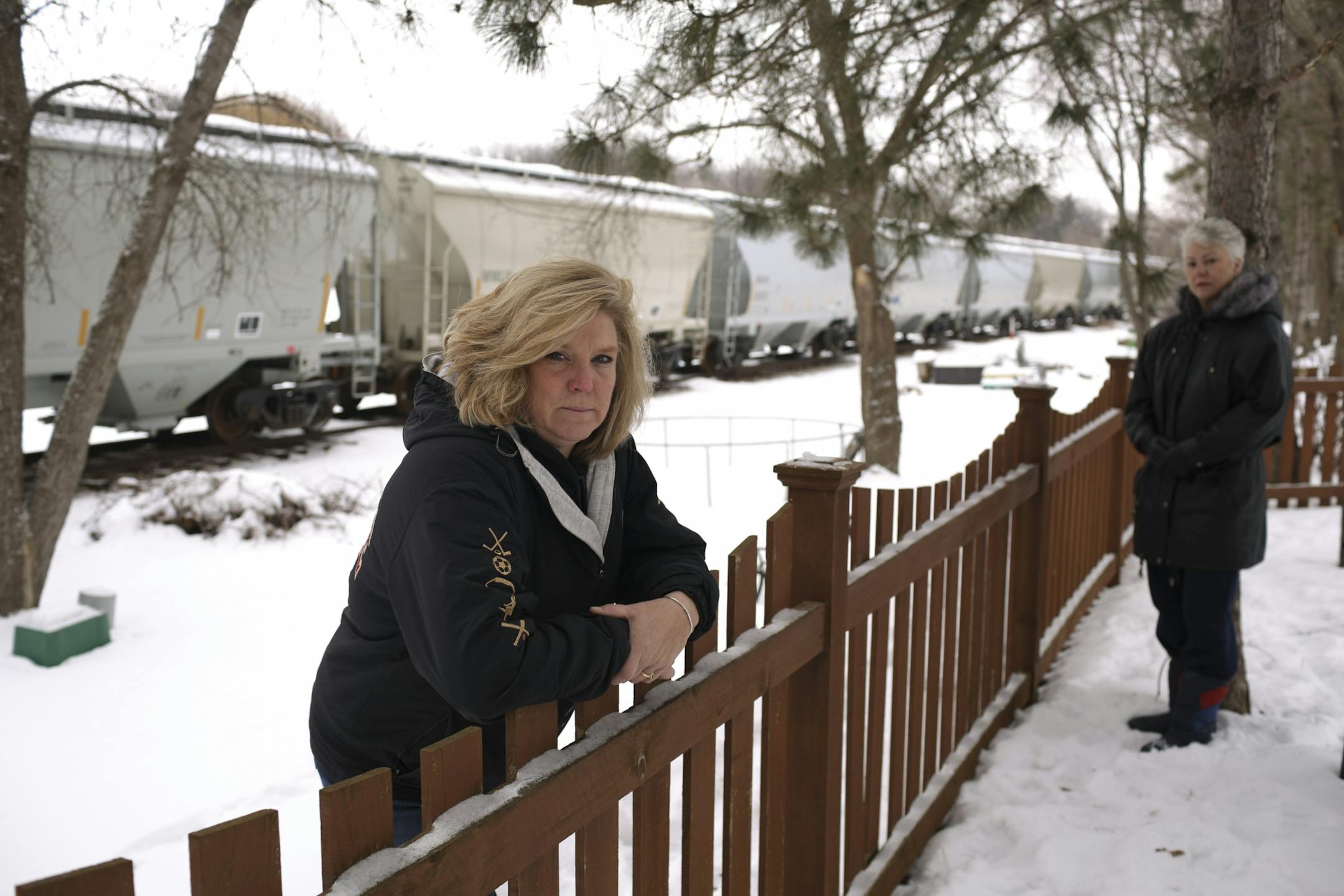 Pam Steinhagen, foreground, and her neighbor, Dee Volz in Steinhagen's back yard Wednesday afternoon.