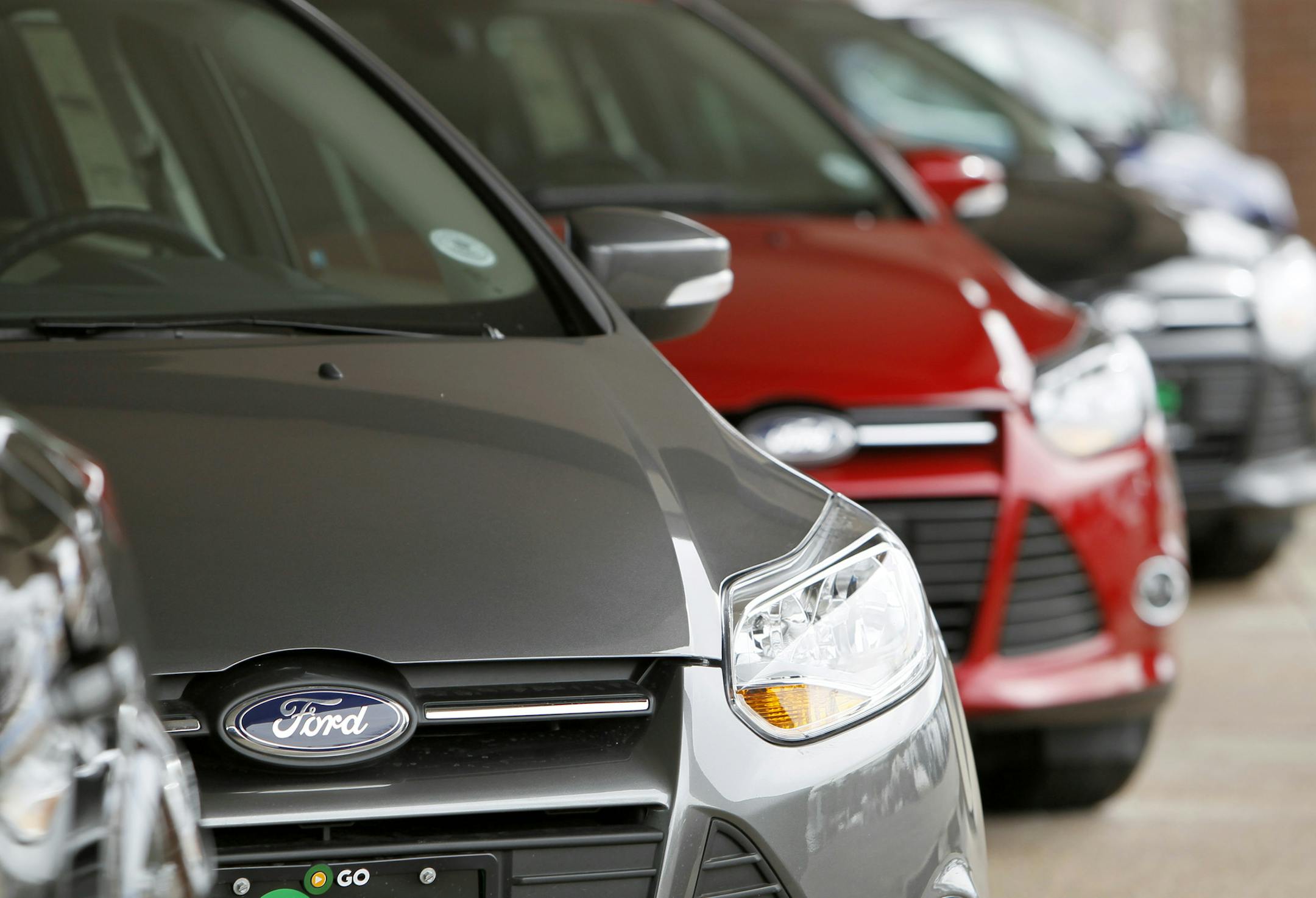 This Feb. 19, 2012 photo, shows a line of 2012 Focus sedans at a Ford dealership in the south Denver suburb of Littleton, Colo. Ford Motor Co. said Thursday, March 1, 2012, its U.S. sales rose 14 percent in February thanks to big demand for its Focus compact car. (AP Photo/David Zalubowski) ORG XMIT: MIN2013040916555473