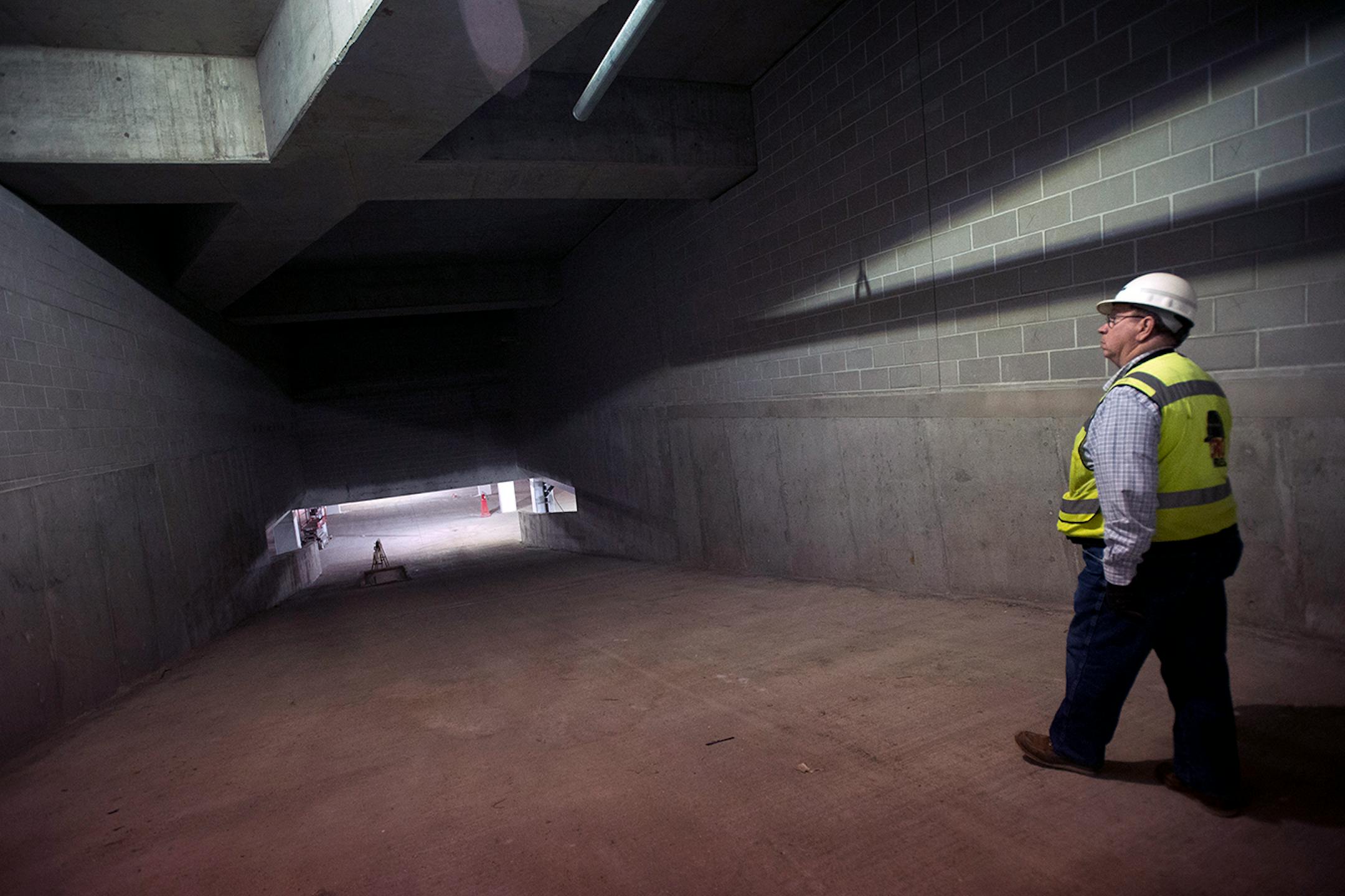 Rich Bistodeau, senior superintendent of the Senate Office Building construction project, leads members of the media to the lower level parking area of the new building during a tour on Tuesday afternoon.