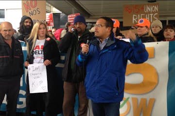 Kip Hedges stands next to Rep. Keith Ellison at a recent demonstration at the Minneapolis-St. Paul Airport.