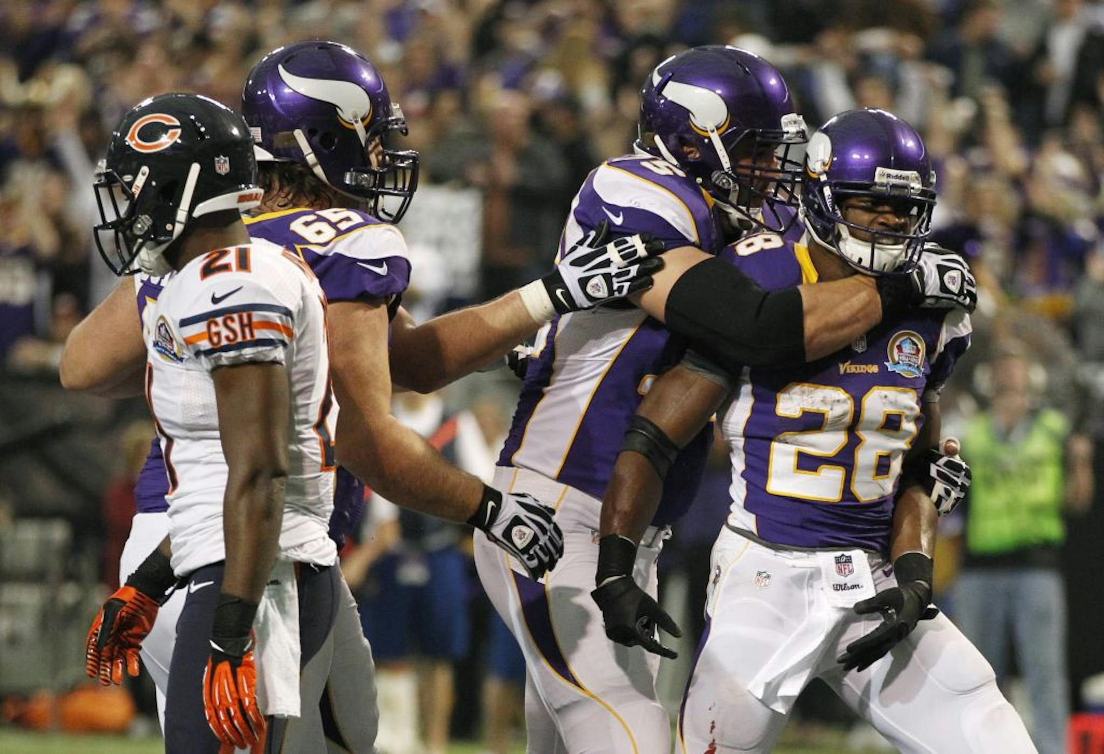 Vikings running back Adrian Peterson celebrated with offensive tackle Matt Kalil during the Dec. 9 victory over the Bears. Kalil and his offensive line teammates have helped Peterson close in on the NFL single-season rushing record.