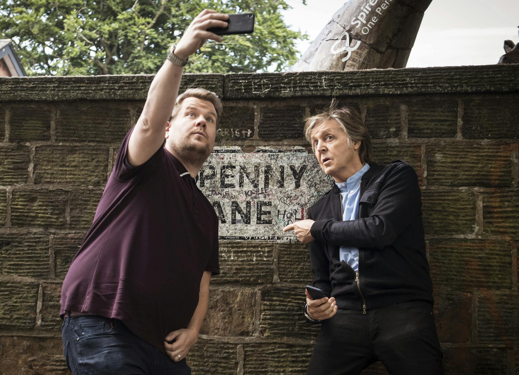 In this image released by CBS, Paul McCartney, right, joins host James Corden as they take a selfie on Penny Lane during the "Carpool Karaoke" segment on "The Late Late Show with James Corden." (Craig Sugden/CBS via AP)