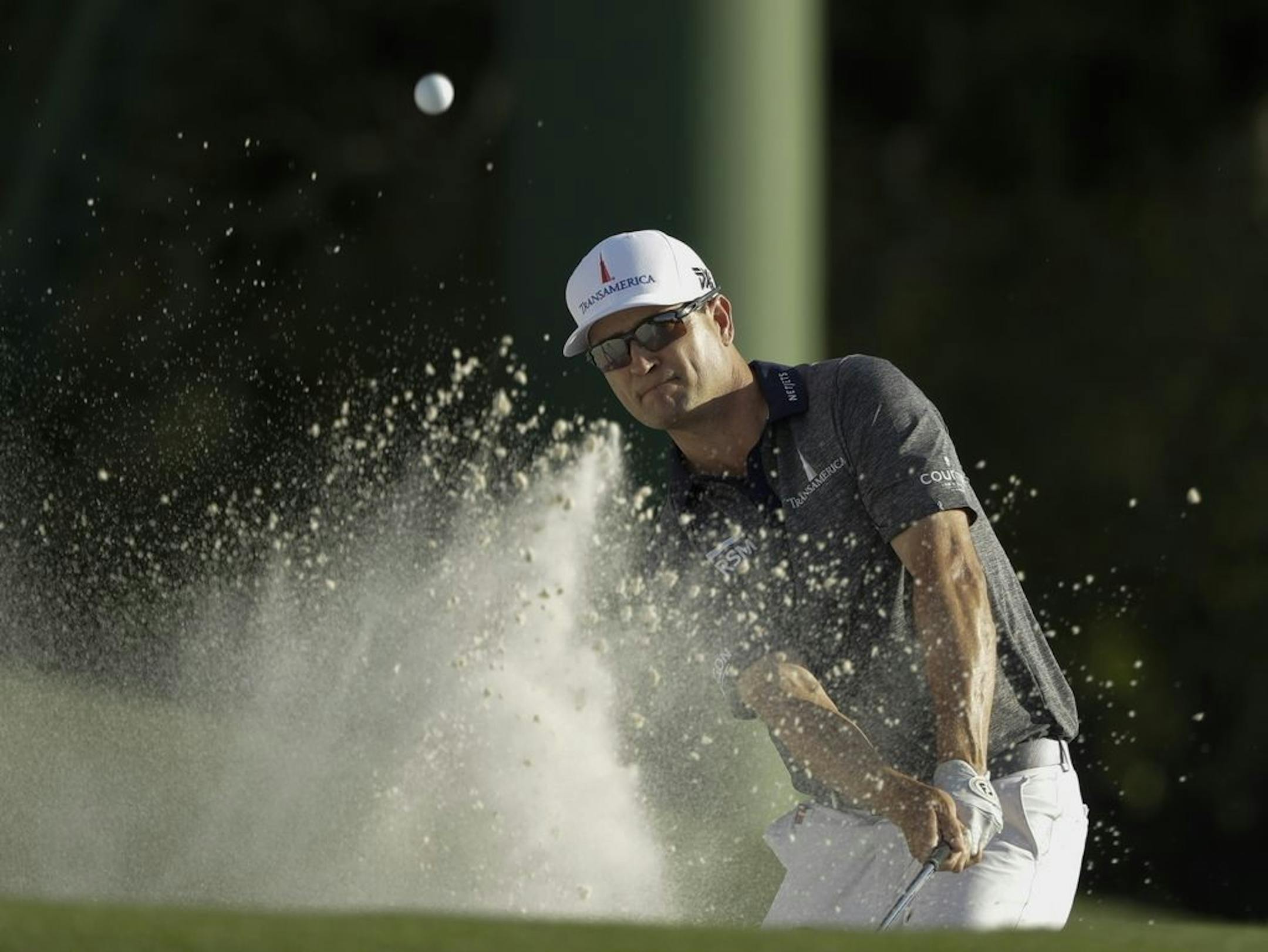 Zach Johnson hits on the 18th hole during the first round for the Masters golf tournament Thursday, April 11, 2019, in Augusta, Ga.