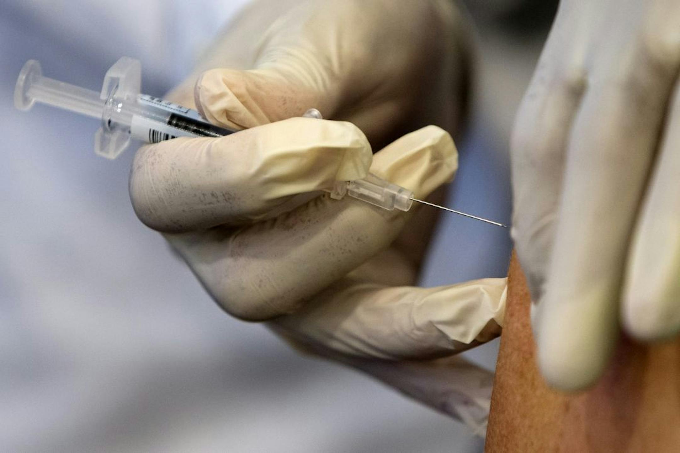 In this Thursday, Sept. 17, 2015 file photo, a nurse gives administers a flu vaccine shot in Washington.