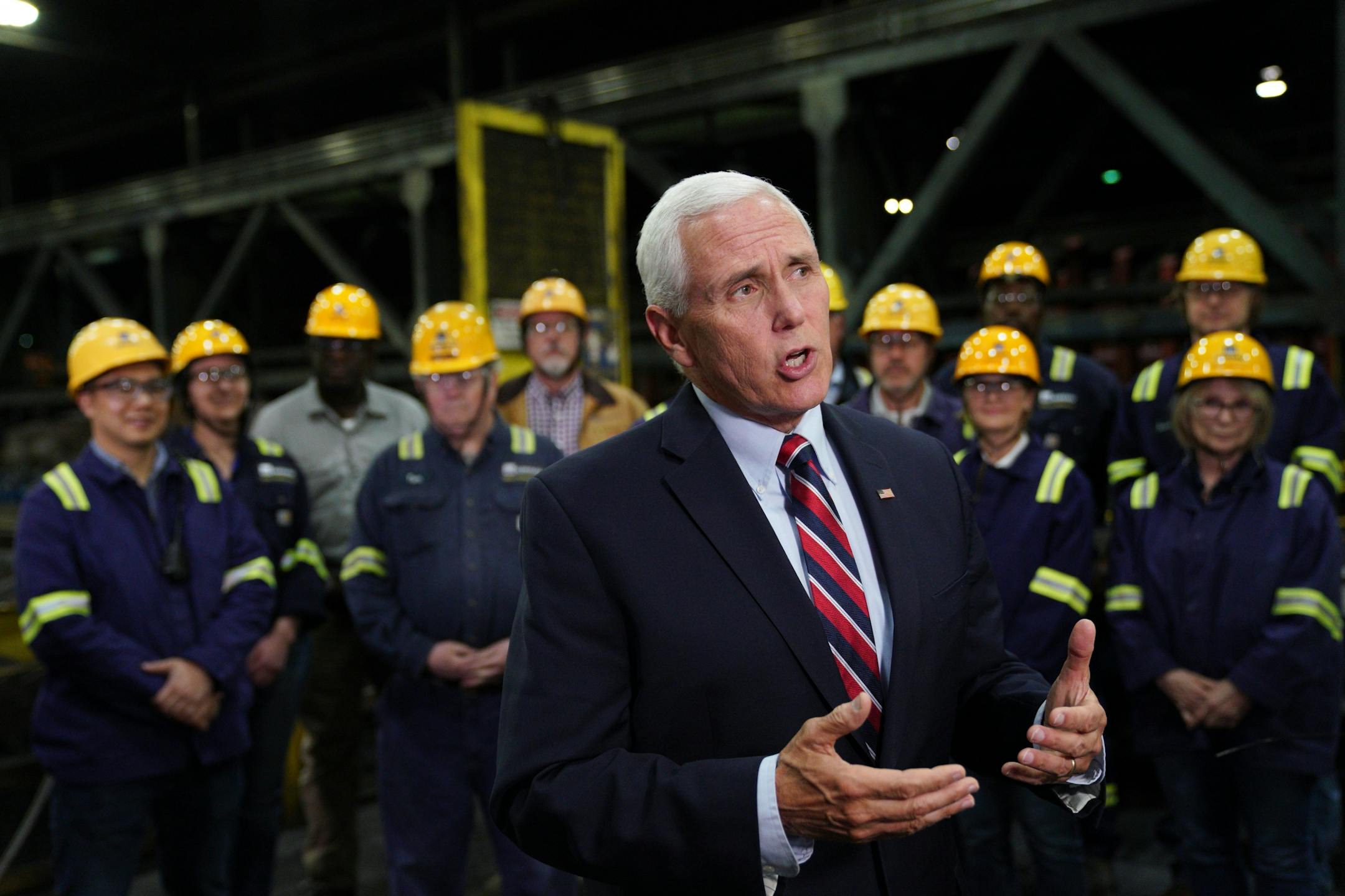 Vice President Mike Pence answered questions from reporters as he stood with a select group of steel workers after giving a speech urging support for President Donald Trump's proposed replacement for the North American Free Trade Agreement at Gerdau Ameristeel Thursday.