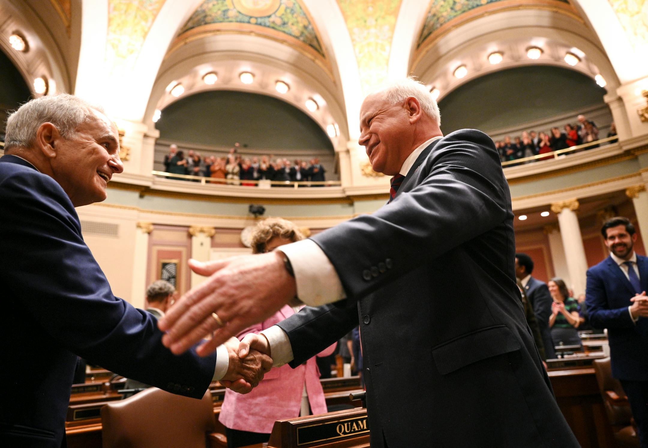 Minnesota Gov. Tim Walz, right, greets distinguished guest and former Gov. Mark Dayton before Walz delivered the State of the State address.