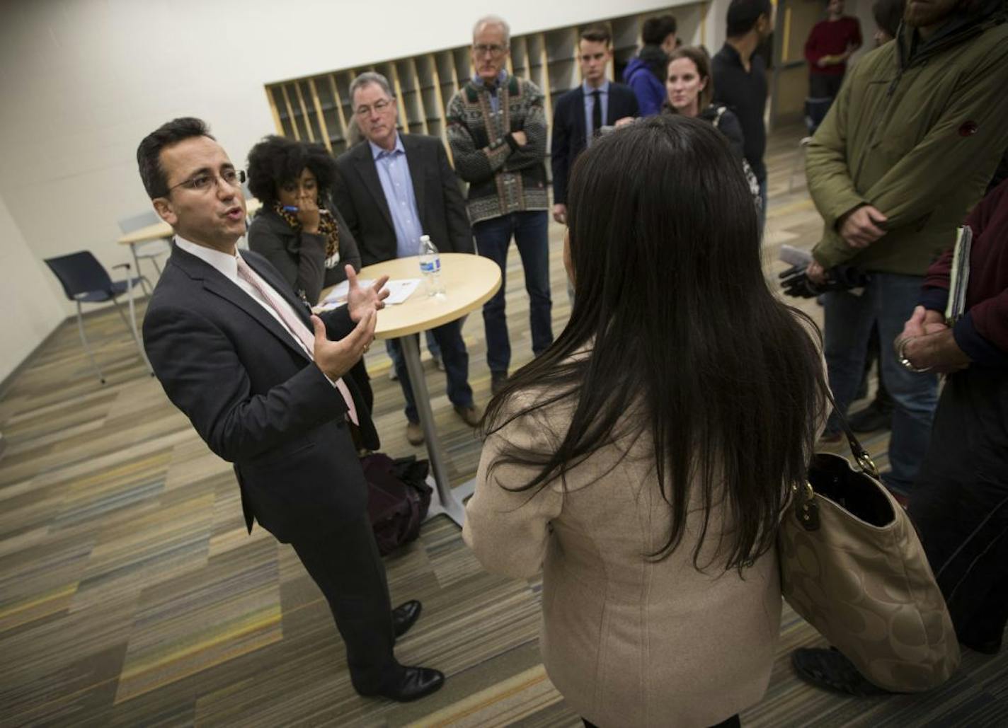 The three final candidates for Minneapolis superintendent met with community members at Webster Elementary on Tuesday, December 2, 2015, in Minneapolis, Minn. In this picture, candidate Sergio Paez, left, talked with a crowd.