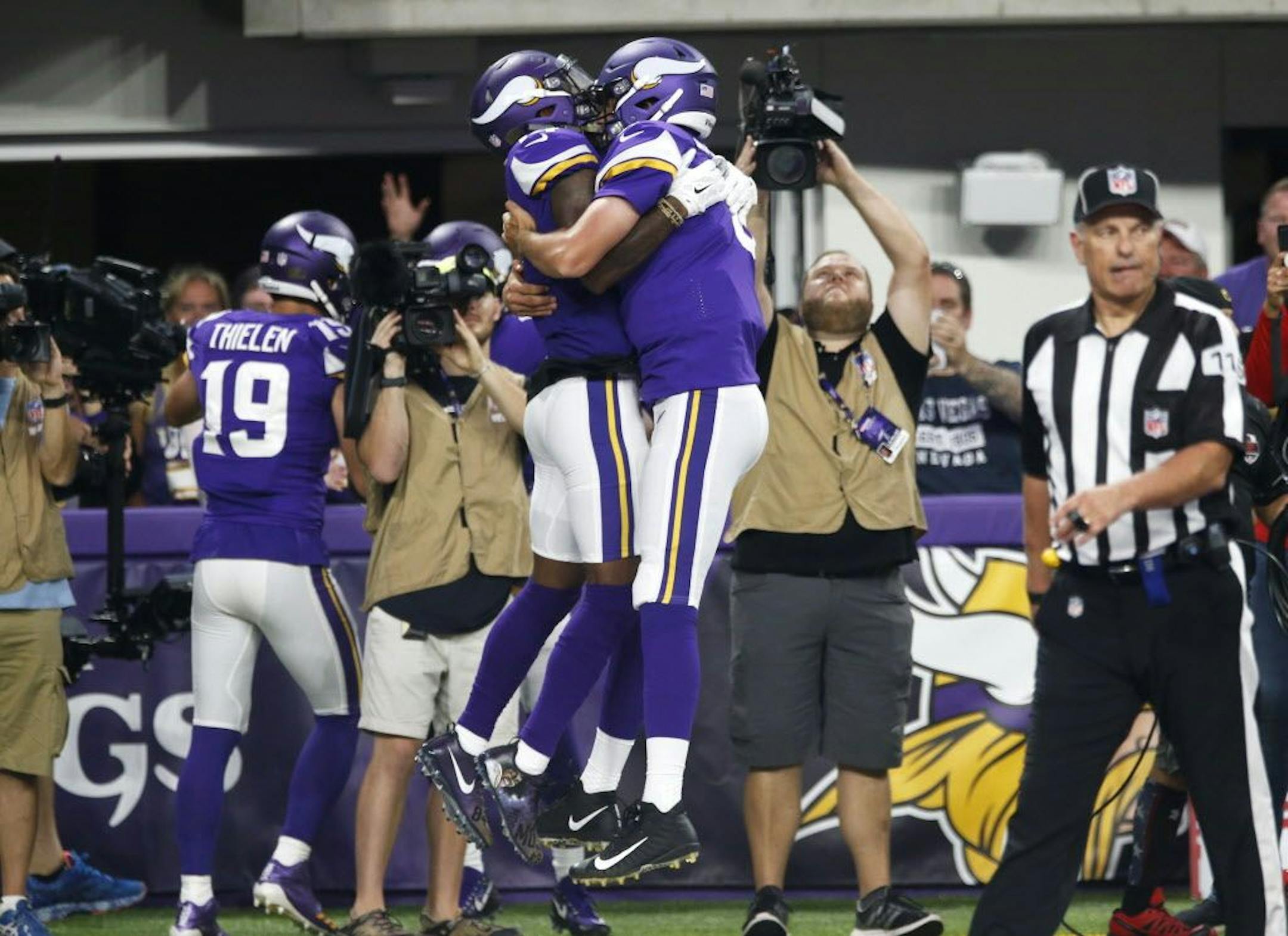 Minnesota Vikings wide receiver Stefon Diggs, left, celebrates with teammate Sam Bradford after catching an 18-yard touchdown pass during the first half of an NFL football game against the New Orleans Saints, Monday, Sept. 11, 2017, in Minneapolis.
