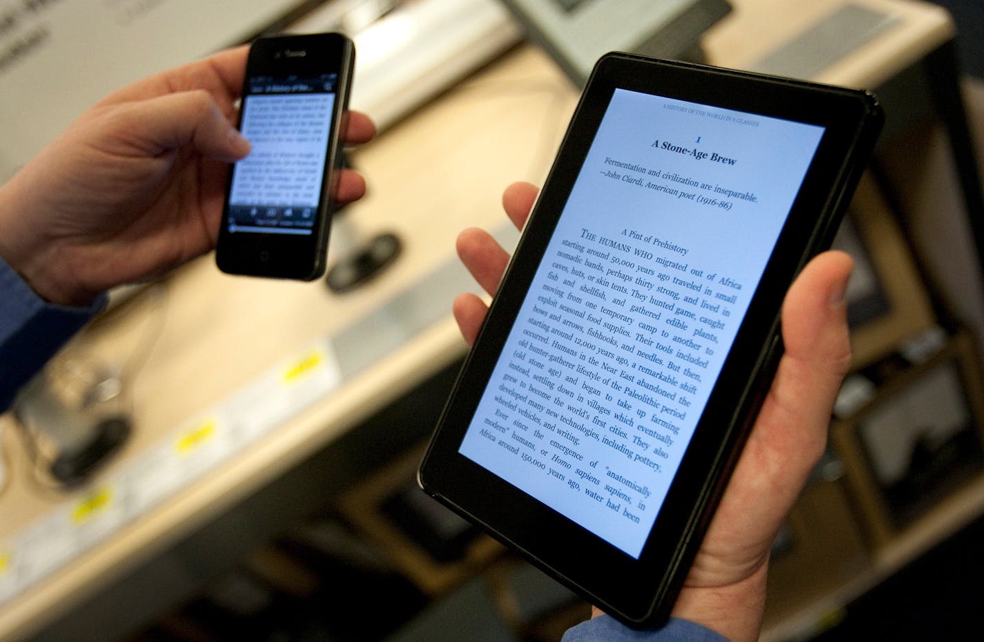 The Amazon.com Inc. Kindle Fire tablet computer, right, is displayed with an Apple Inc. iPhone 4 for a photograph at a Best Buy Co. store in New York, U.S., on Tuesday, Nov. 15, 2011.