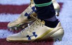 FILE- In this Dec. 10, 2017, file photo Jacksonville Jaguars running back T.J. Yeldon warms up wearing Under Armour cleats before an NFL football game