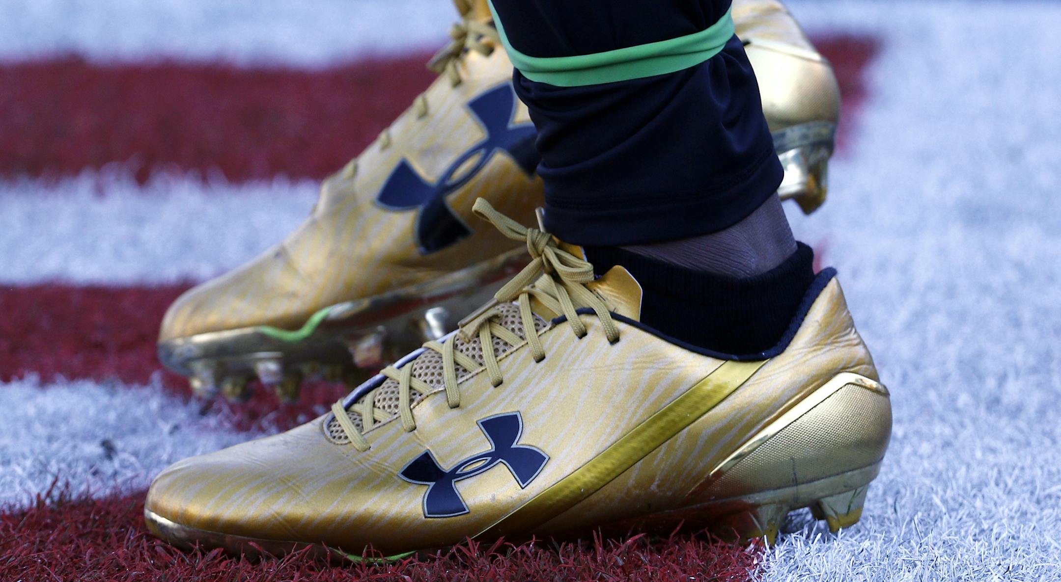 FILE- In this Dec. 10, 2017, file photo Jacksonville Jaguars running back T.J. Yeldon warms up wearing Under Armour cleats before an NFL football game against the Seattle Seahawks in Jacksonville, Fla. Under Armour, Inc. reports financial results Tuesday, Feb. 12, 2019. (AP Photo/Stephen B. Morton, File)