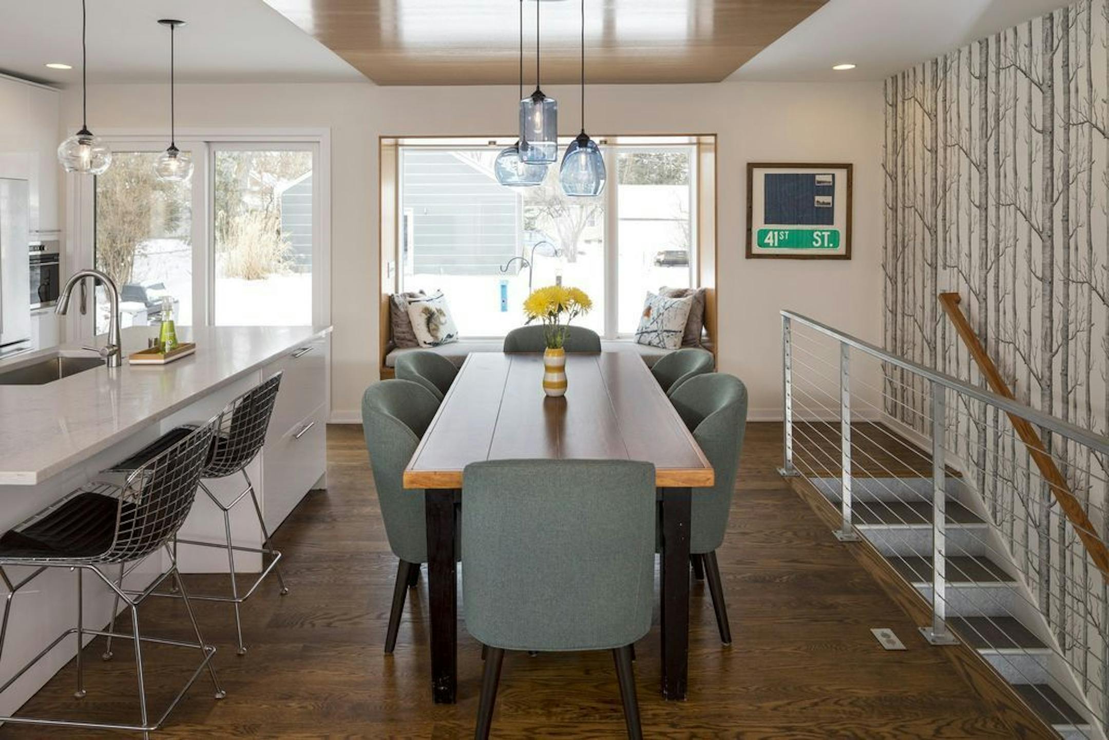 Once separated by walls, the living room, kitchen and dining area all flow together. "Opening up the floor plan made the house live so much larger," said architect Eric Odor.