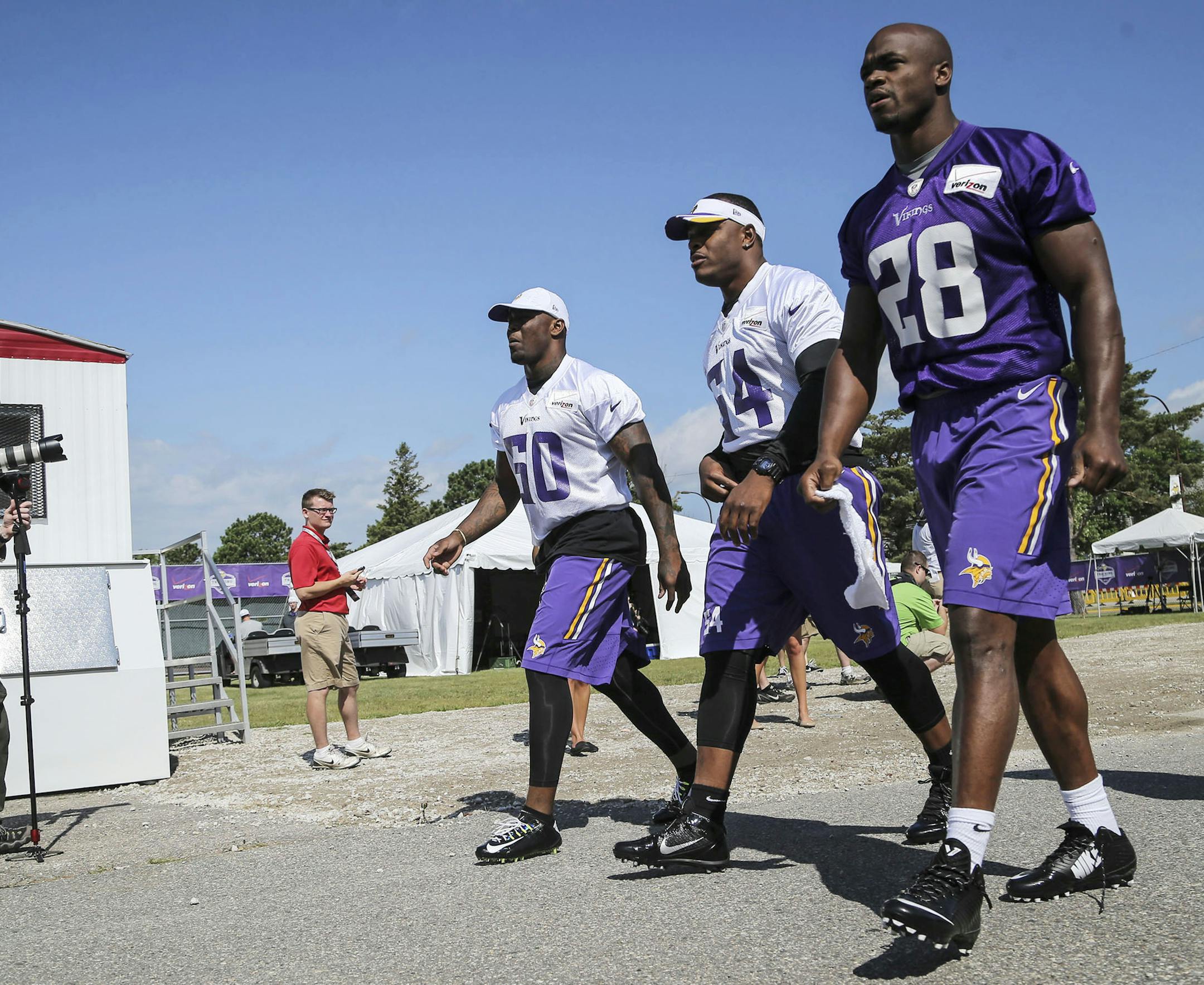 Minnesota Vikings runningback Adrian Peterson (28) arrives for the morning walk-through during training camp with linebackers Jasper Brinkley (54) and Gerald Hodges (50) Friday, July 24, 2014, at Mankato State University in Mankato, MN.] (DAVID JOLES/STARTRIBUNE) djoles@startribune Minnesota Vikings training camp Friday, July 24, 2014, in Mankato, MN.