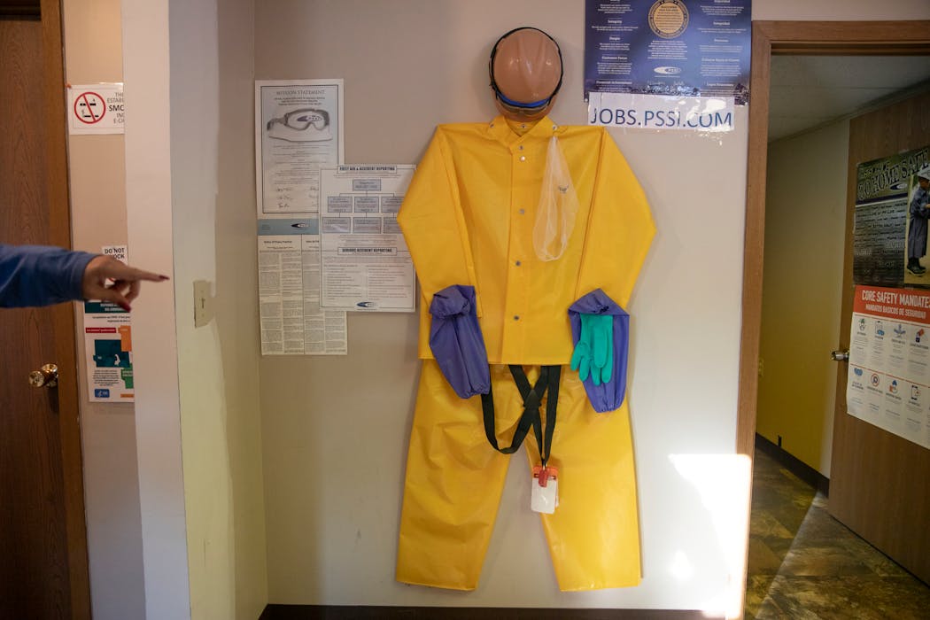 Protective equipment hangs in a recruiting office for Packers Sanitation Services, where migrant children were hired to clean slaughterhouses overnight, in Worthington, Minn., on Oct. 17, 2022. 