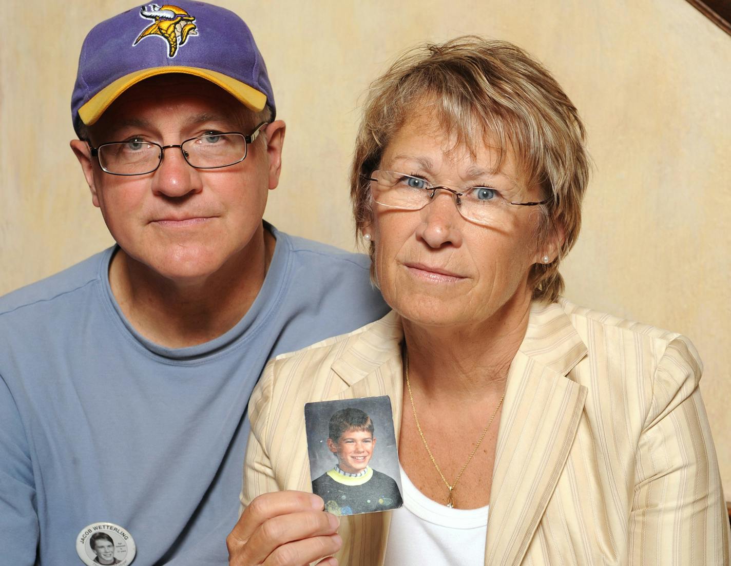 In this 2009 photo, Jerry Wetterling and wife, Patty, hold a photo of their son, Jacob, who was abducted in October 1989 in St. Joseph, Minn., and is still missing. Wetterling keeps a scrapbook of news clippings about abducted children being reunited with their families years later. It's a source of hope for her.