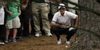 Justin Rose, of England, examines his shot in the rough off the seventh fairway during the fourth round of the Masters golf tournament Sunday, April 1