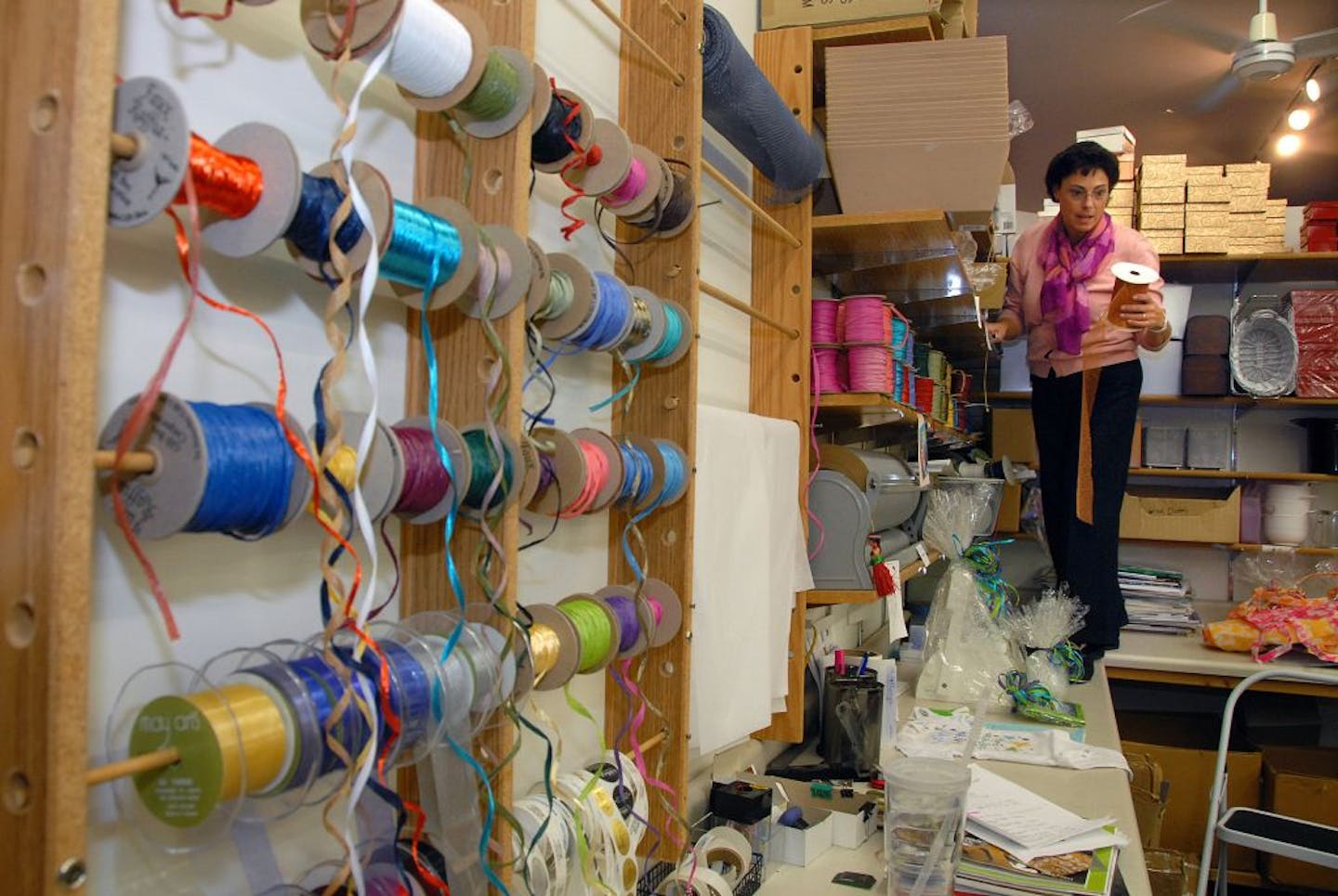 Hillary Feder of Hillary's Personalized Gifts in Hopkins looked for the perfect ribbon for a gift in her back shop.