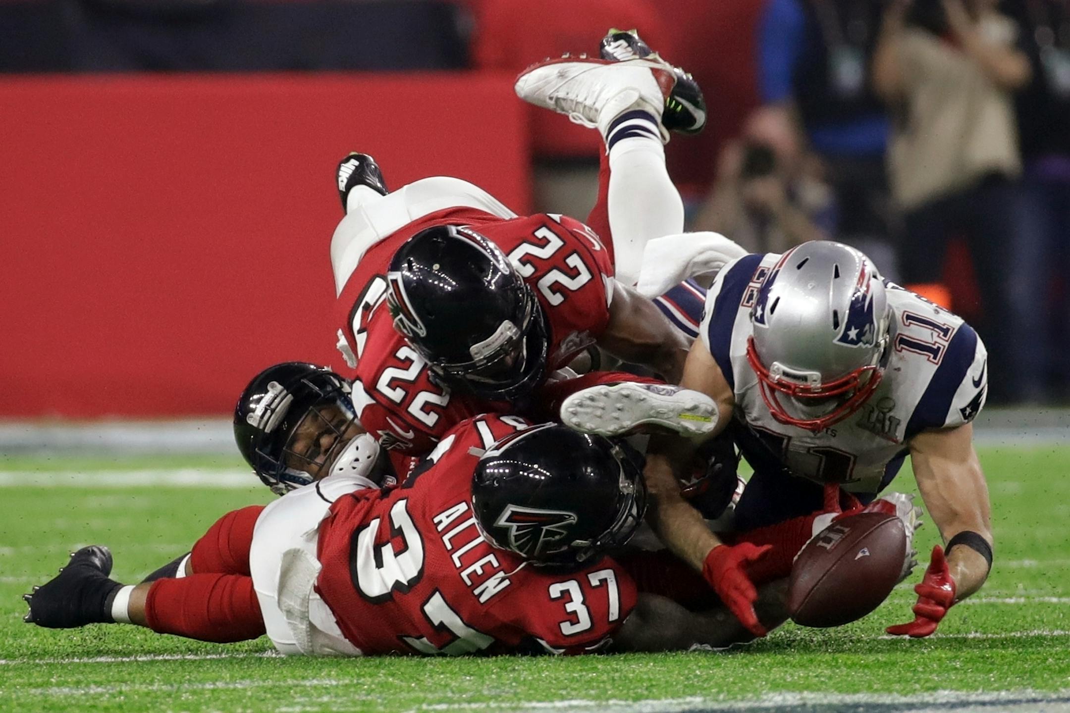 Patriots wide receiver Julian Edelman caught a deflected ball for a catch while the Falcons' Ricardo Allen and Keanu Neal defended during the second half of Super Bowl 51 Sunday.