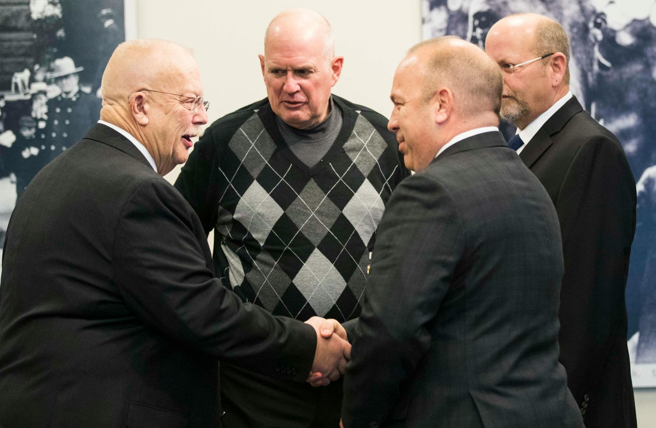 Retired St. Paul Police officers Richard Klein, from left, James Groh and Patrick Scott, far right, are greeted by St. Paul Police chief Todd Axtell, second from right, before the ceremony. ] LEILA NAVIDI ï leila.navidi@startribune.com BACKGROUND INFORMATION: Thirty-six years after 6-year-old Cassie Hansen was kidnapped, strangled and left in dumpster, the team of officers and a civilian will be recognized for breaking one of St. Paul's most infamous murder cases during a ceremony at St. Paul Po