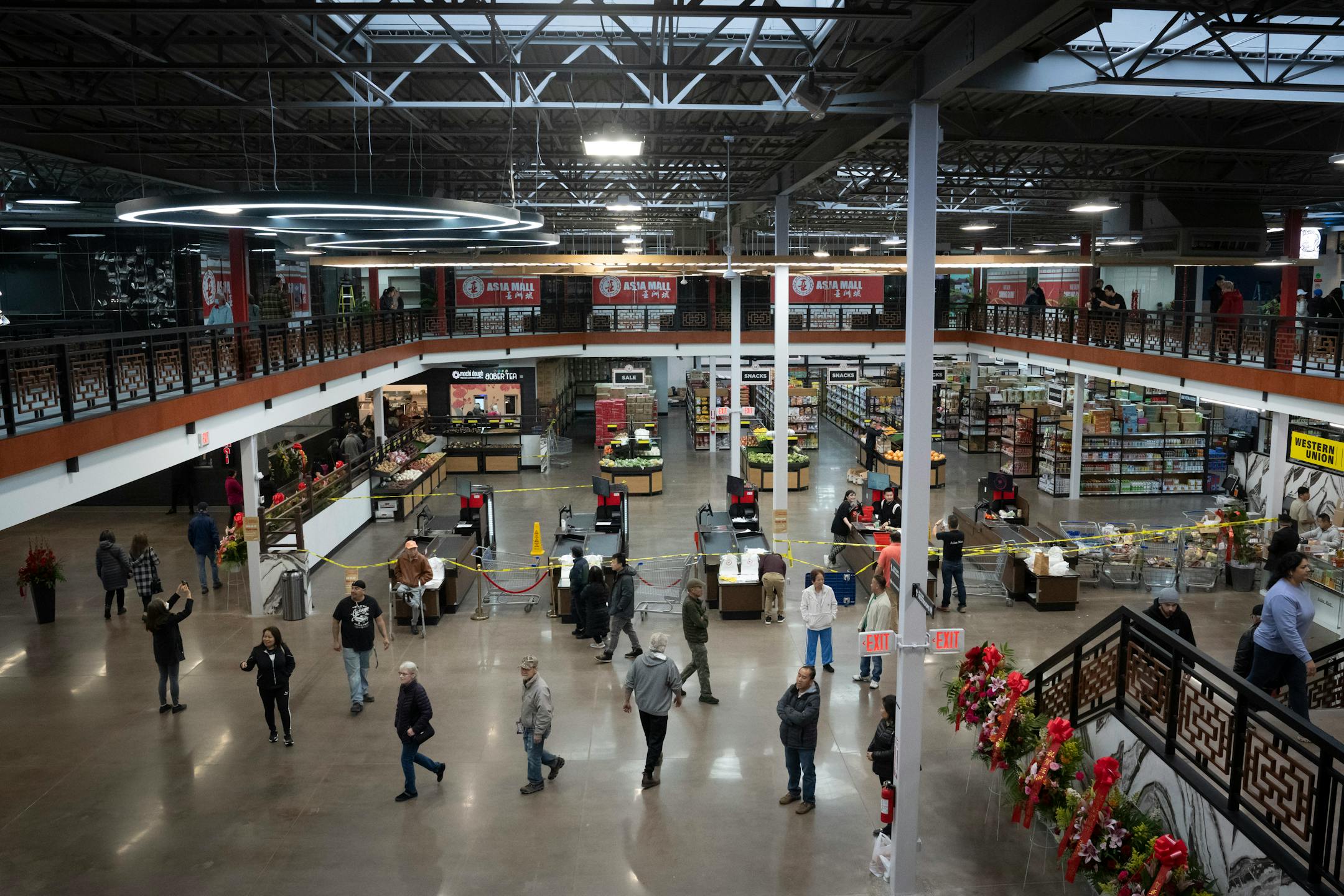 Crowds walk through a soft opening for the new Asia Mall on Thursday, Nov. 10, 2022 in Eden Prairie, Minn.