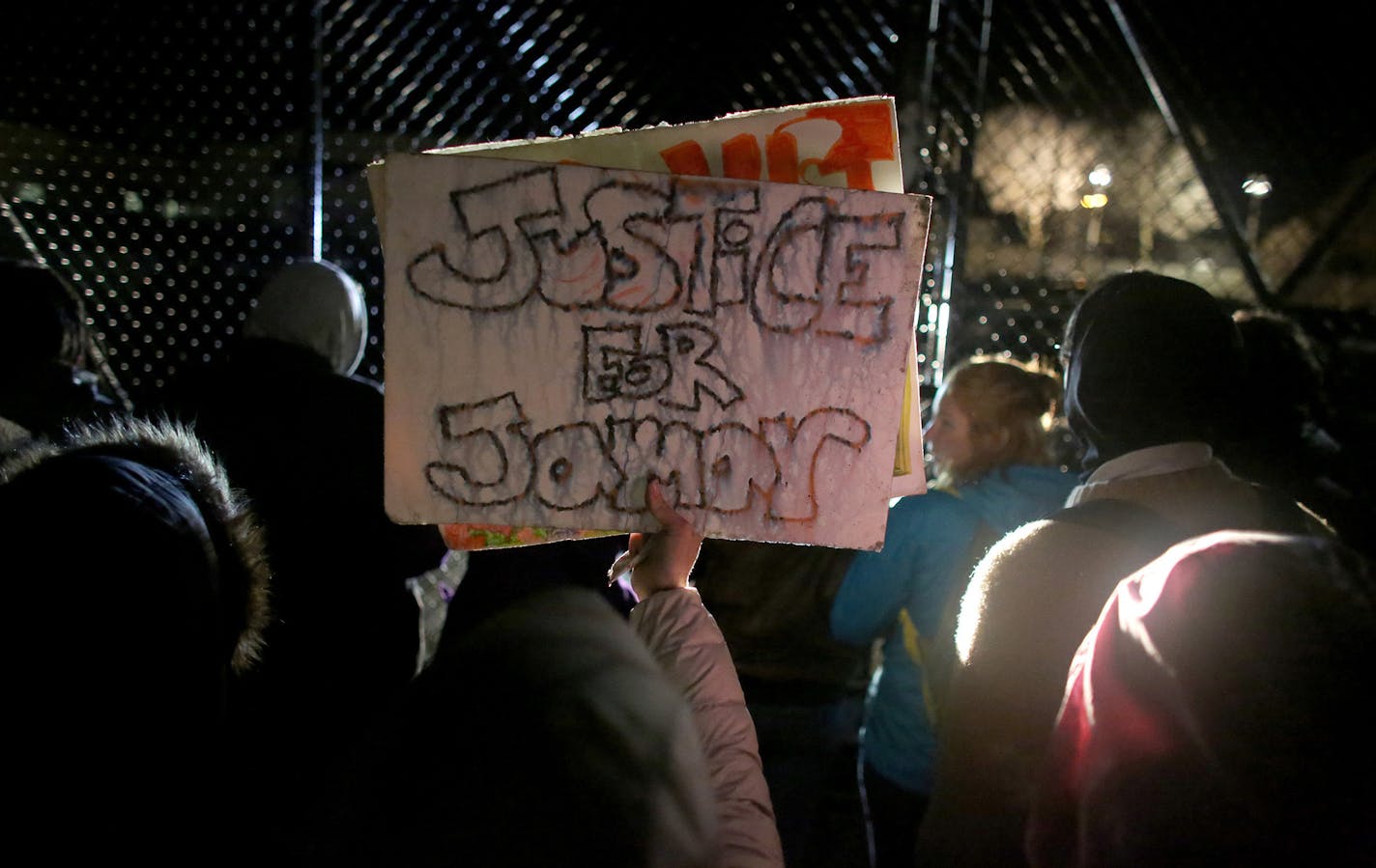 Protesters moved to the gated parking lot of the Minneapolis Fourth Precinct to chant during their outside occupation outside surrounding area. ] (KYNDELL HARKNESS/STAR TRIBUNE) kyndell.harkness@startribune.com Black Lives Matter protested in front of Minneapolis Fourth Precinct in Minneapolis Min., Wednesday November 18, 2015. ORG XMIT: MIN1511182040590683 ORG XMIT: MIN1512151156030539