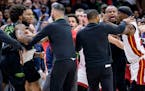 New Orleans Pelicans forward Naji Marshall, left, and Miami Heat forward Jimmy Butler, right, are separated during a scuffle in he second half of an N