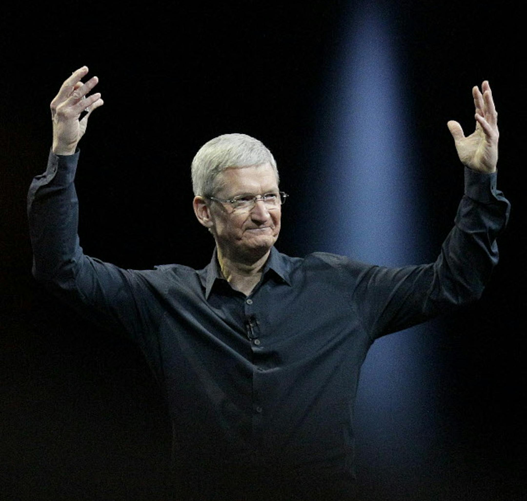 FILE - In this June 2, 2014 file photo, Apple CEO Tim Cook gestures during the Apple Worldwide Developers Conference in San Francisco. Apple's stock touched a new high Wednesday, Aug. 20, 2014, reflecting investors' renewed faith in Cook's ability to outwit the competition and expand the technological hit factory built by the late Steve Jobs. (AP Photo/Jeff Chiu, File) ORG XMIT: MIN2014082116530855
