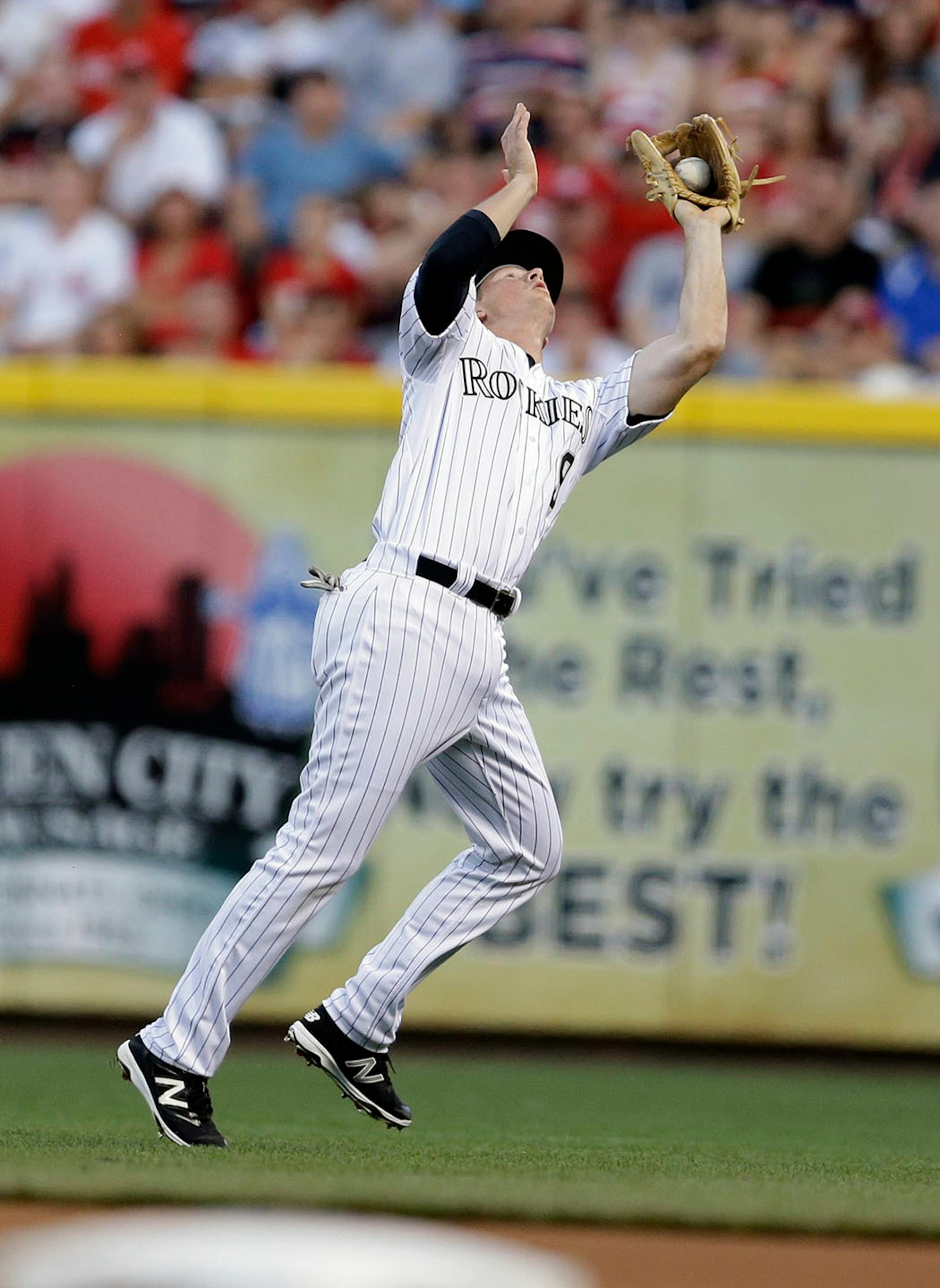 National League's DJ LeMahieu, of the Colorado Rockies, makes a catch on a ball hit by American League's Lorenzo Cain, of the Kansas City Royals, during the first inning of the MLB All-Star baseball game, Tuesday, July 14, 2015, in Cincinnati.