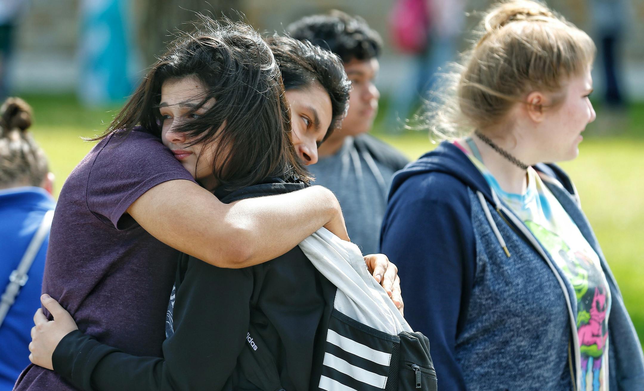 Santa Fe High School freshman Caitlyn Girouard, center, hugs her friend outside the Alamo Gym where students and parents wait to reunite following a shooting at Santa Fe High School Friday, May 18, 2018, in Santa Fe, Texas. (Michael Ciaglo/Houston Chronicle via AP)