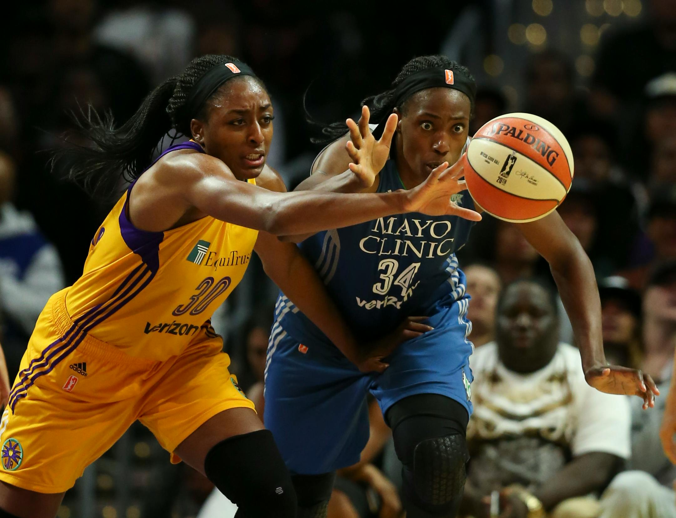 Los Angeles Sparks forward Nneka Ogwumike (30) and Minnesota Lynx center Sylvia Fowles (34) reached for the ball after Ogwumike knocked it loose.